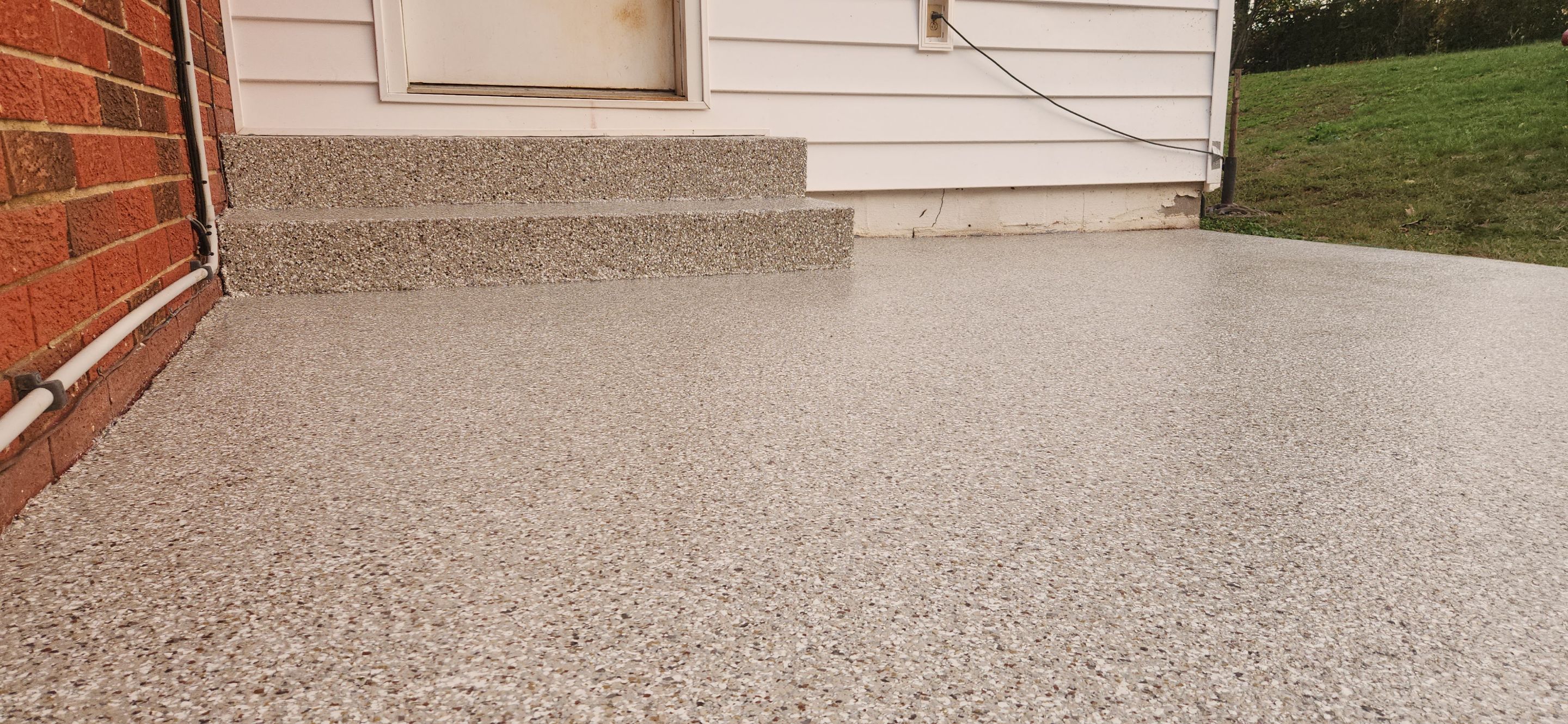Back Patio using Creekbed by Elite Floor Solutions
