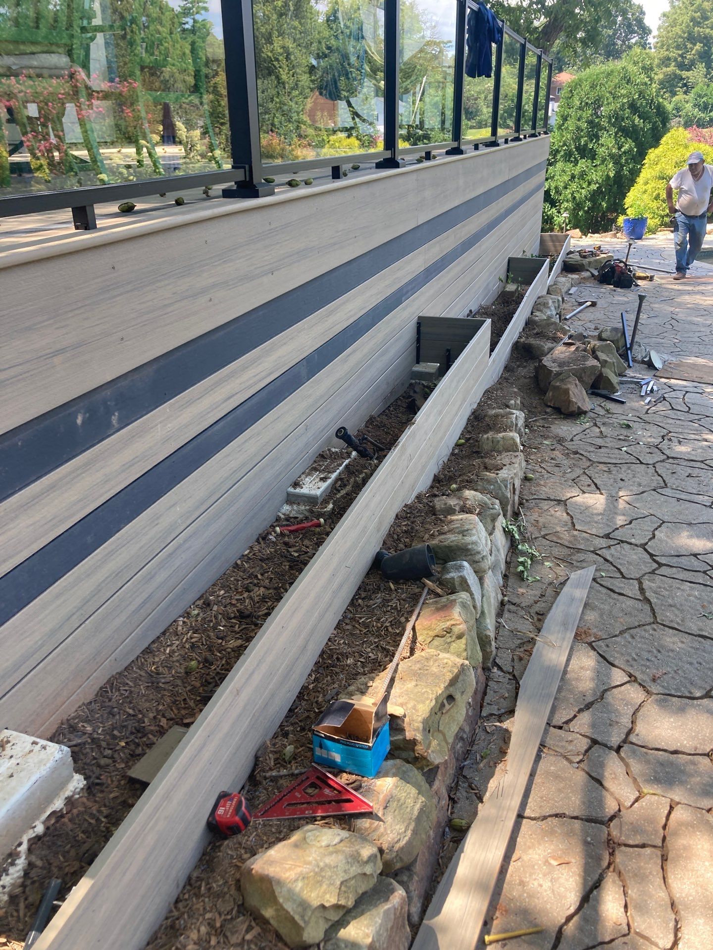 Deck Resurface with Glass Paneling and Deckorators Voyage Series Products by Nelson Exteriors 