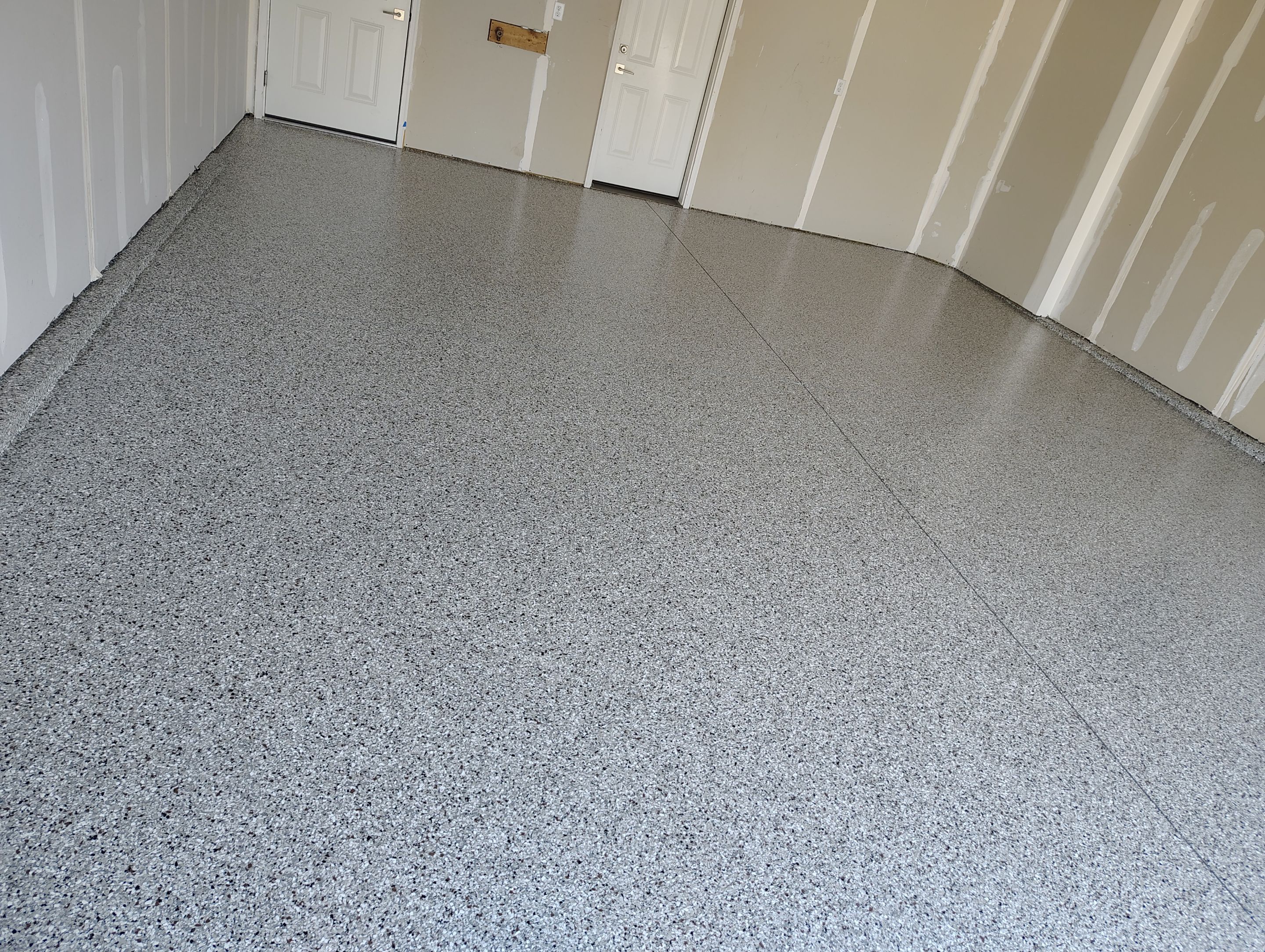 Custom Epoxy Garage Floor and Patio Coating in Sioux Falls by Select Painting, Coatings & Garage Cabinets