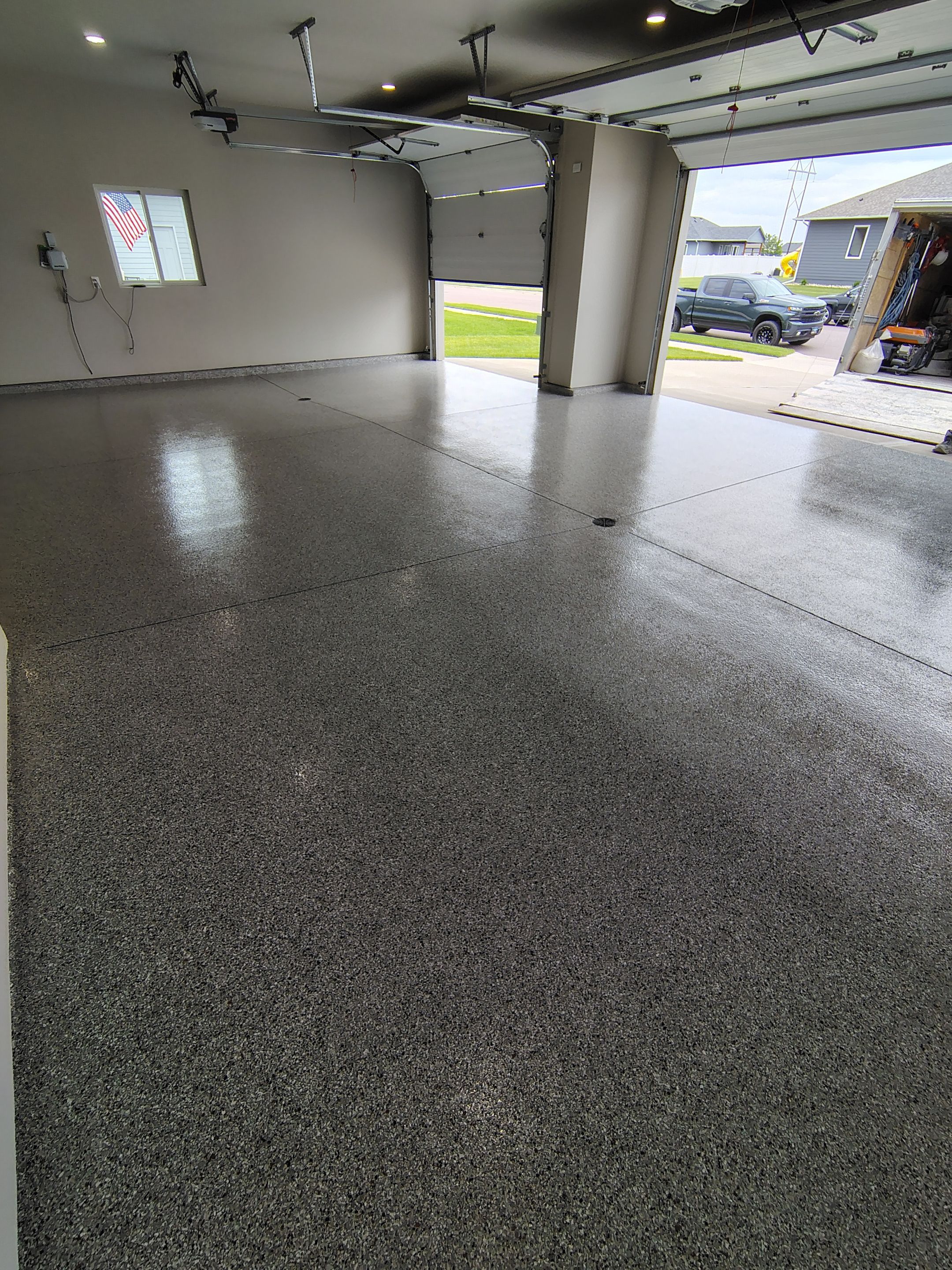Grey Speckled Epoxy Garage Floor Coating in Sioux Falls by Select Painting, Coatings & Garage Cabinets
