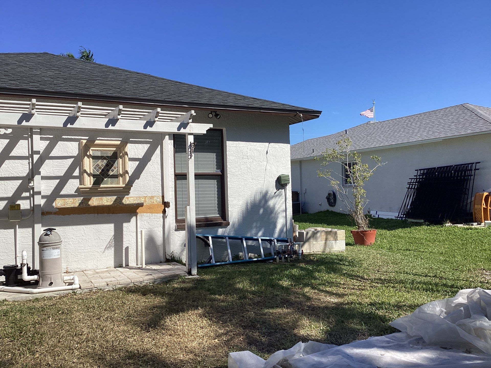 Brown Gutter + White and Brown Downspouts in Cape Coral FL by Gutter Professors