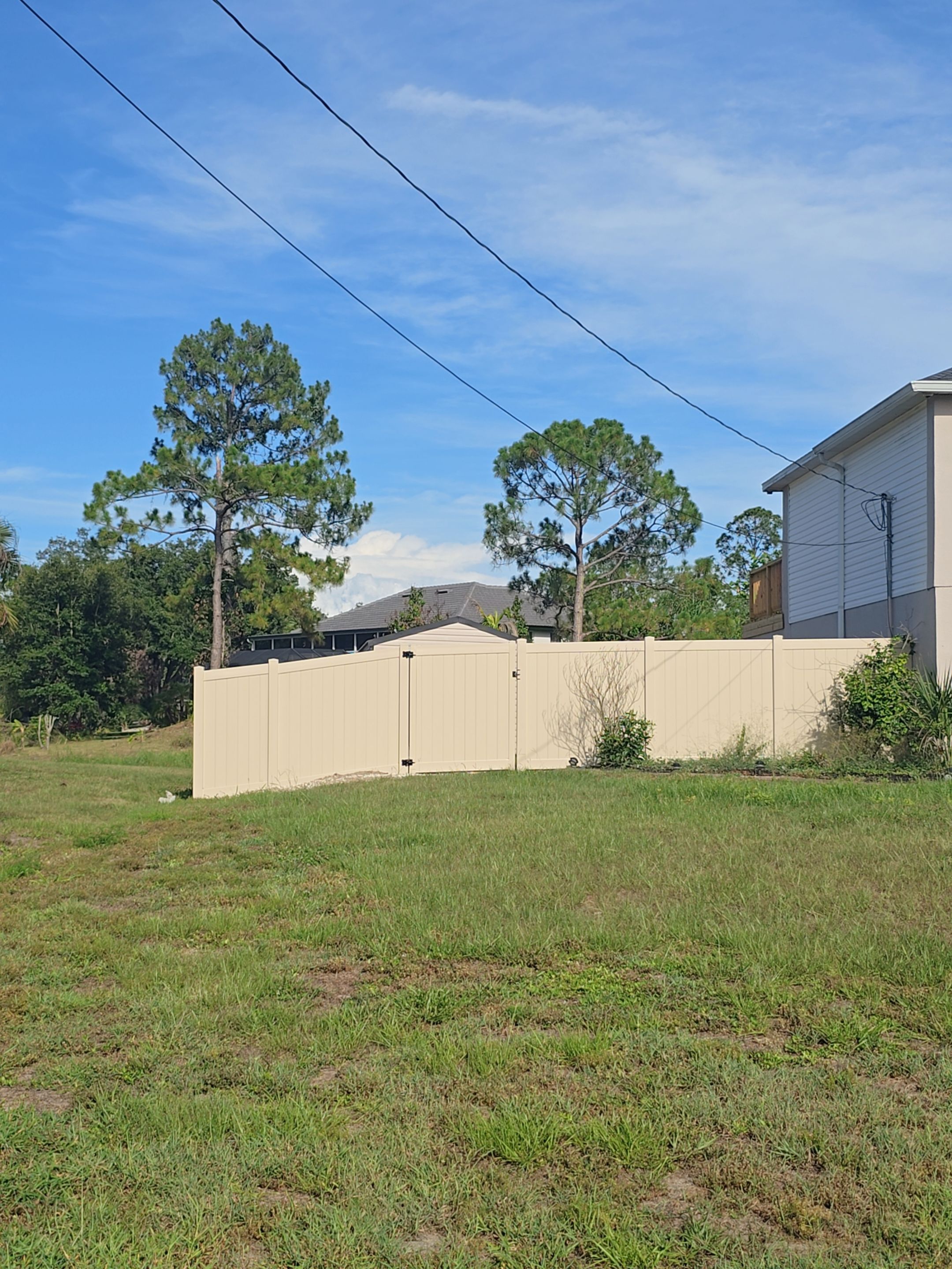 Tan Vinyl Privacy Fence and Gate Installation in North Port by True Fence LLC