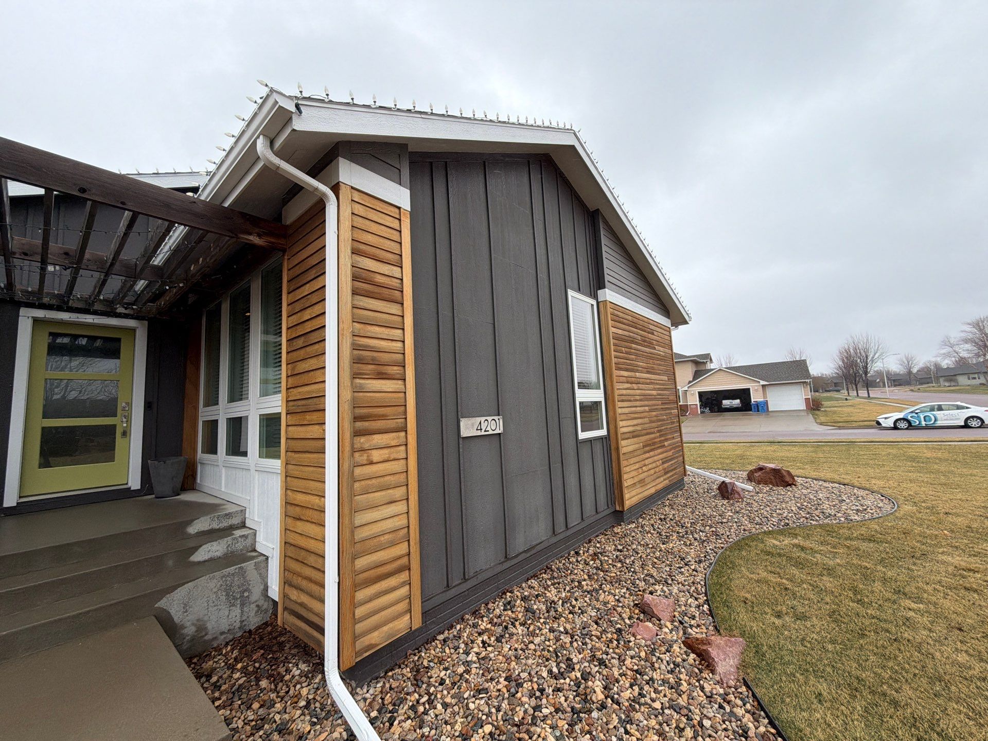 Modern Exterior Transformation Featuring Dark Board and Batten Siding in Sioux Falls by Select Painting, Coatings & Garage Cabinets