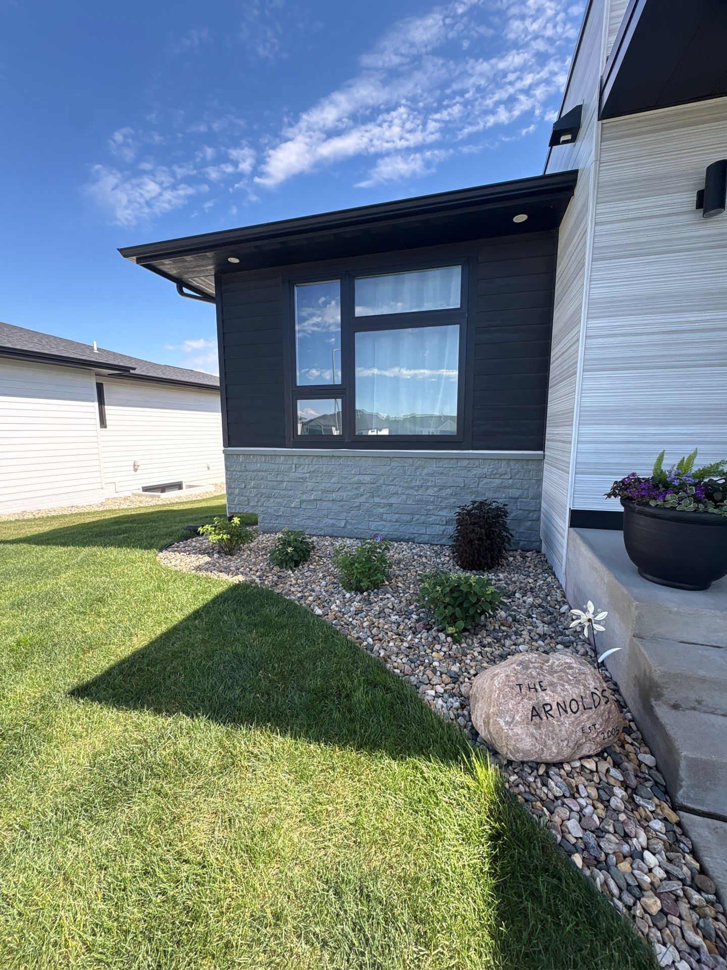 Modern Exterior Update with Siding and Stone Masonry in Sioux Falls by Select Painting, Coatings & Garage Cabinets