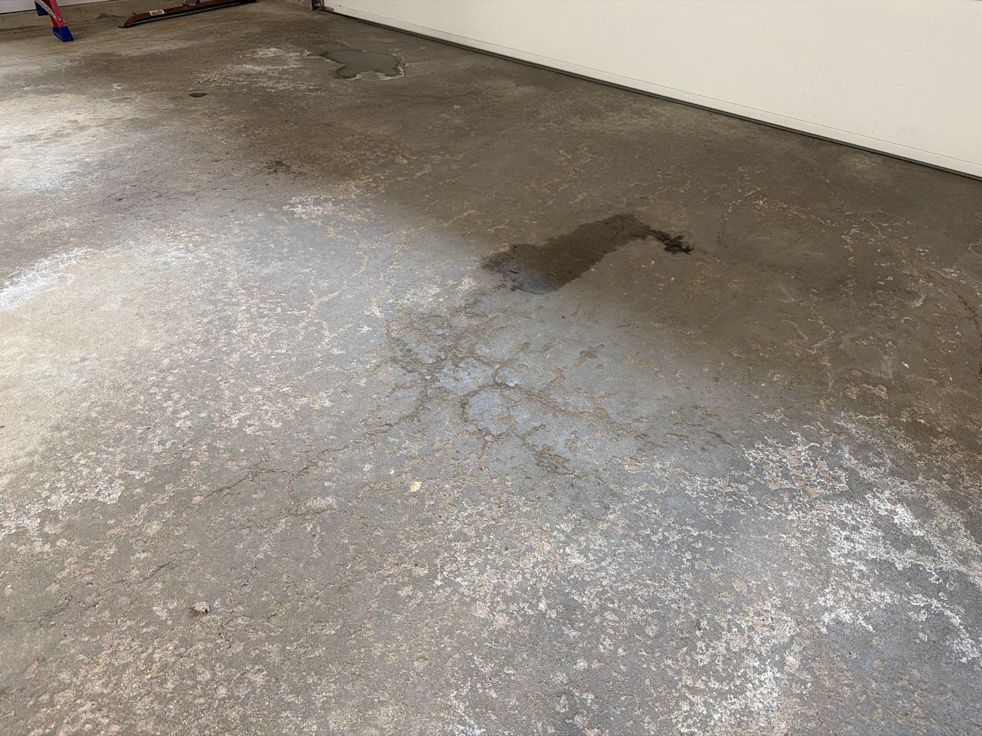 Feather Grey Garage Floor Coating Installation in Sioux Falls by Select Painting, Coatings & Garage Cabinets