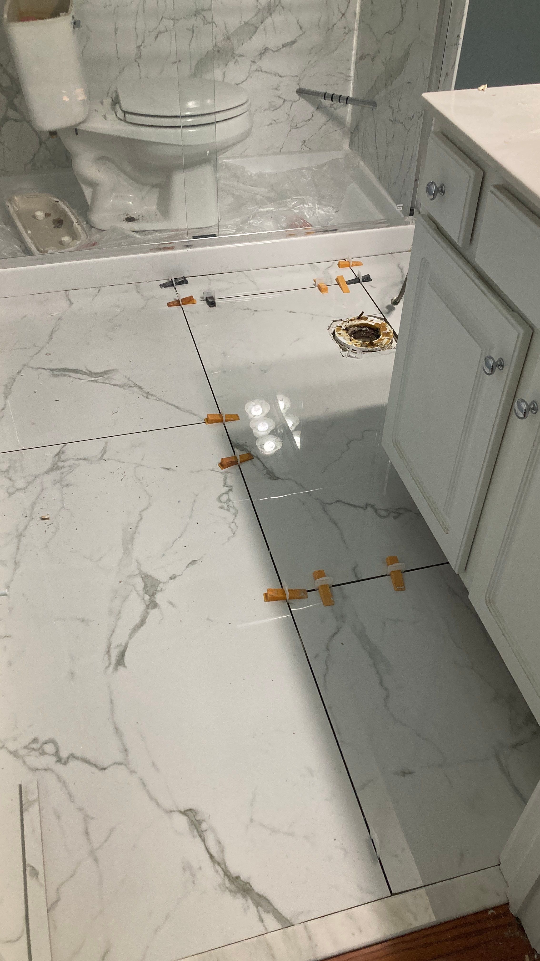 Lovely marbled bathroom floor  by Footprints Floors of Nashville