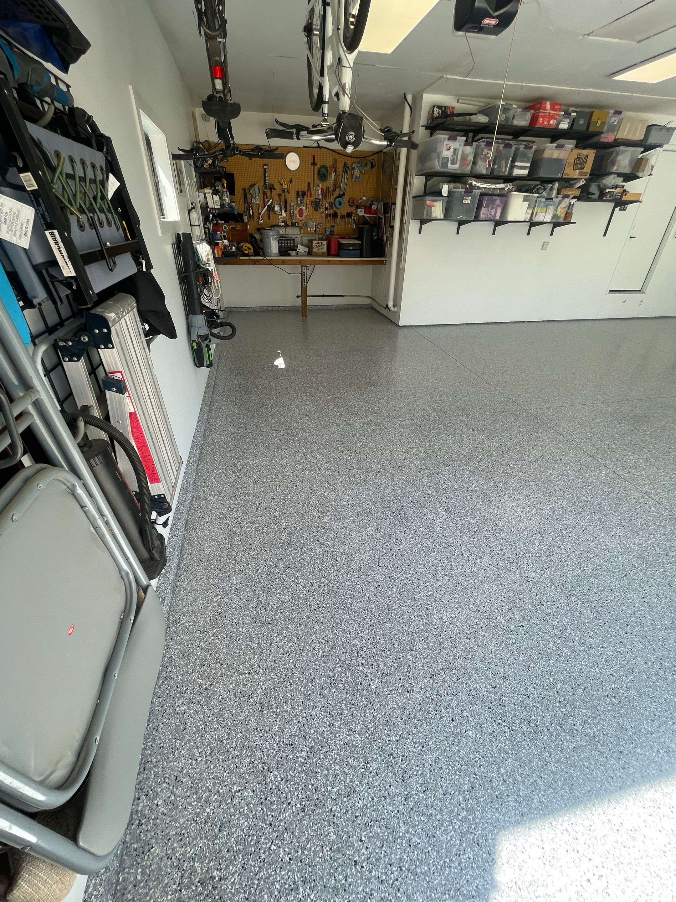 Feather Grey Garage Floor Coating Installation in Sioux Falls by Select Painting, Coatings & Garage Cabinets
