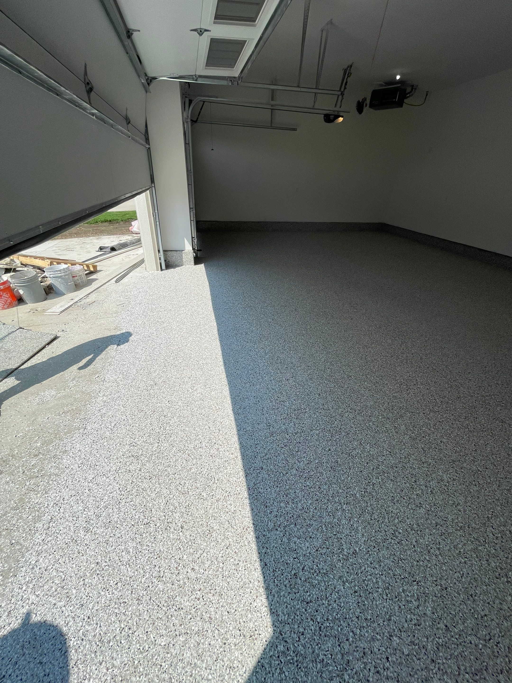Grey Speckled Garage Floor Coating in Sioux Falls by Select Painting, Coatings & Garage Cabinets