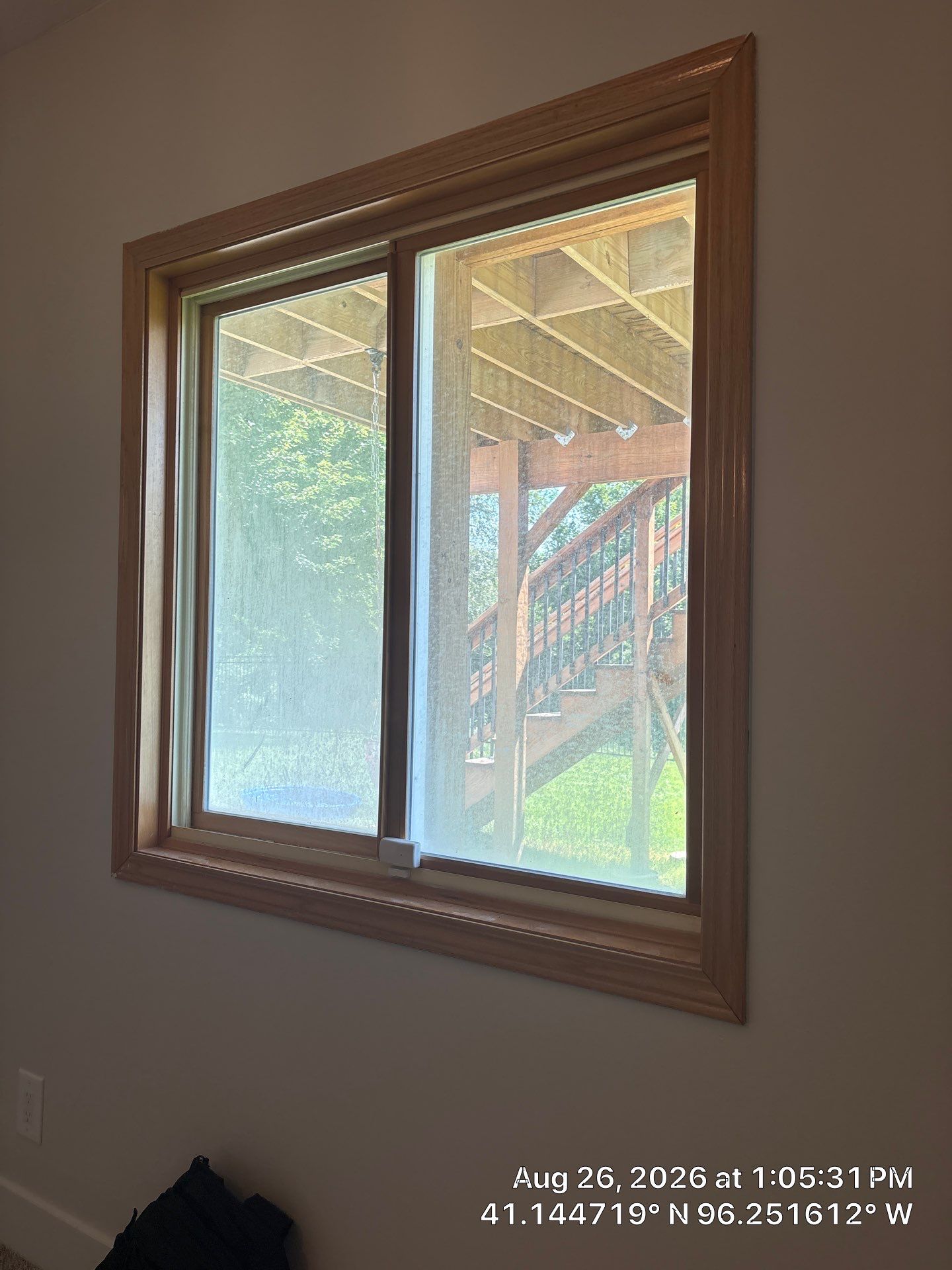 Residential Sliding Window Installation With Natural Wood Trim by CompanyCam Sales Demo