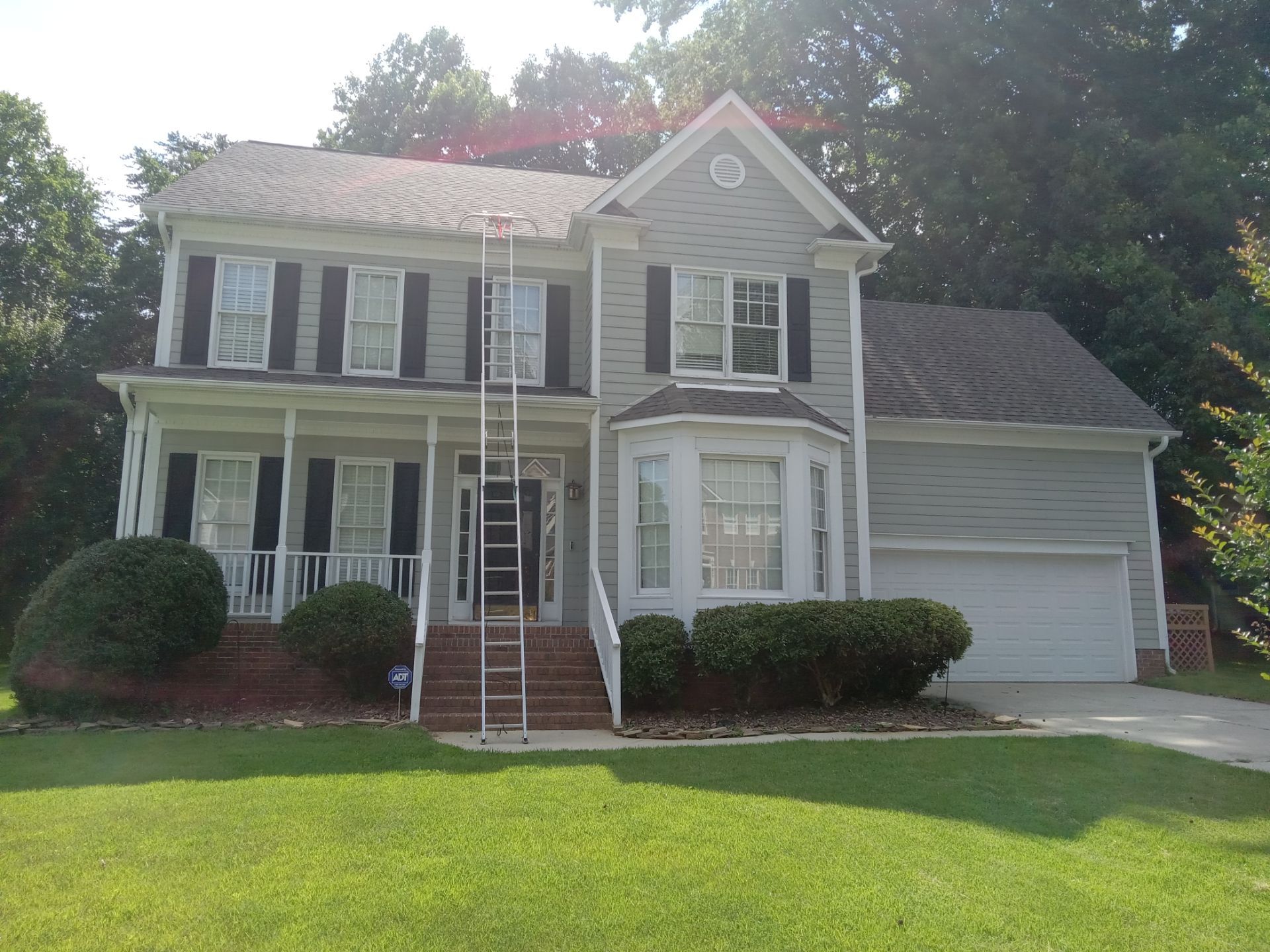 pressure washing exterior siding driveway and sidewalk removing dirt grime for a clean refreshed appearance