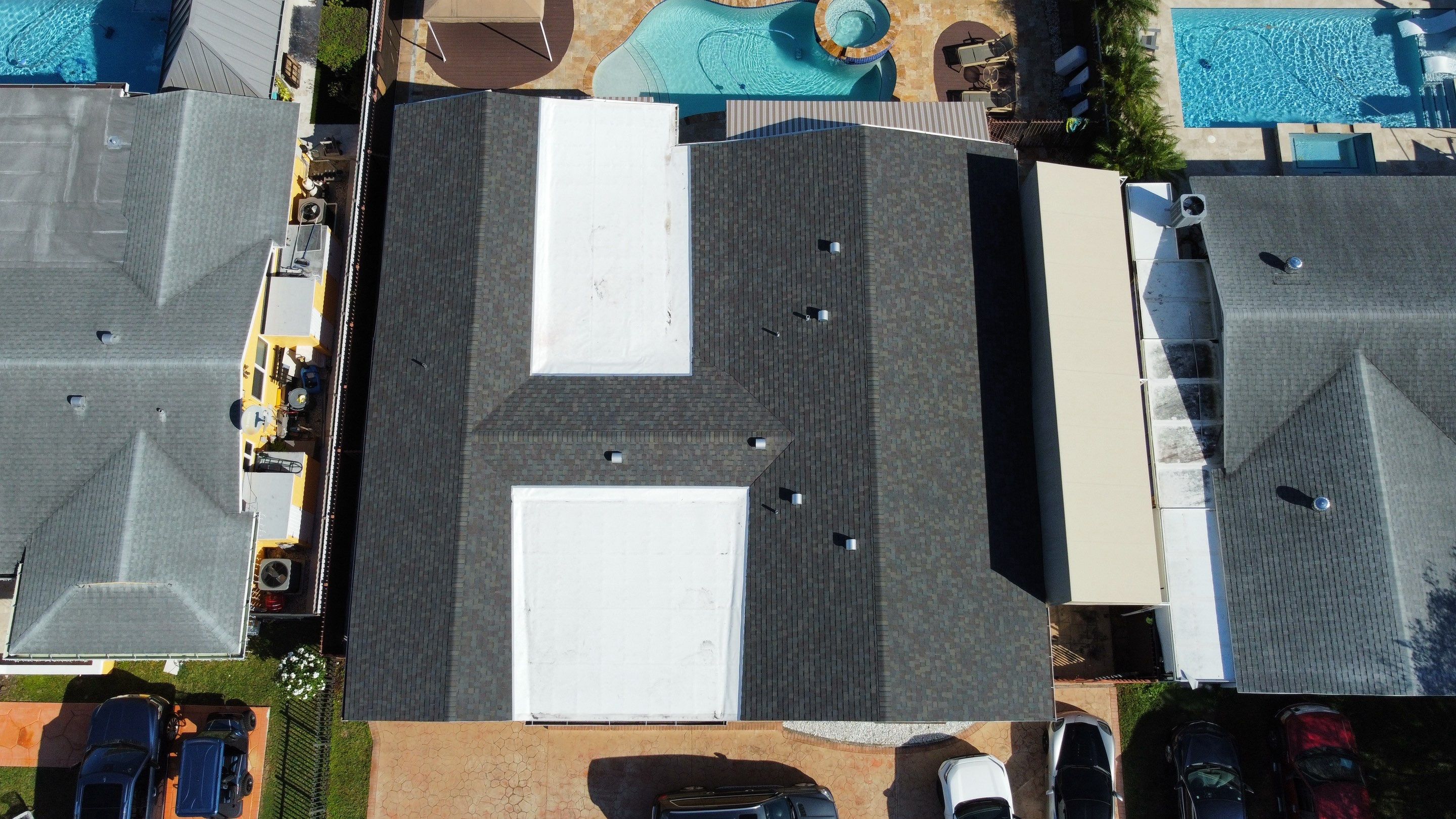 Residential Roofing Installation using Shingle reroof on slope and TPO single ply on flat roof. by BOB HILSON & CO INC