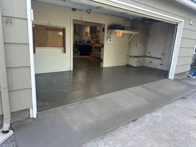 Concrete garage floor replacement with a broom finished apron 