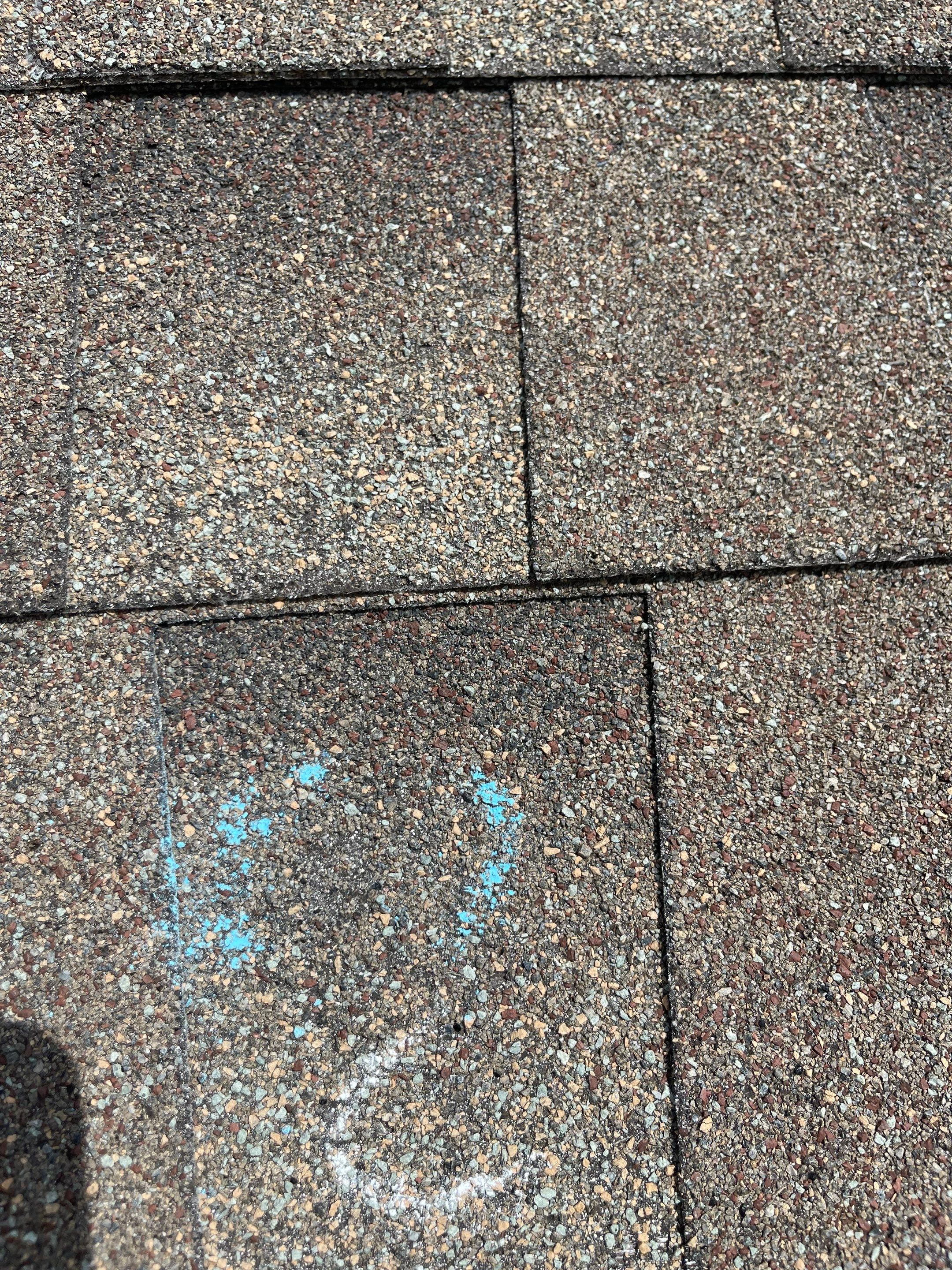 Hail Damage on a Roofing System by Icon Roofing And Construction 