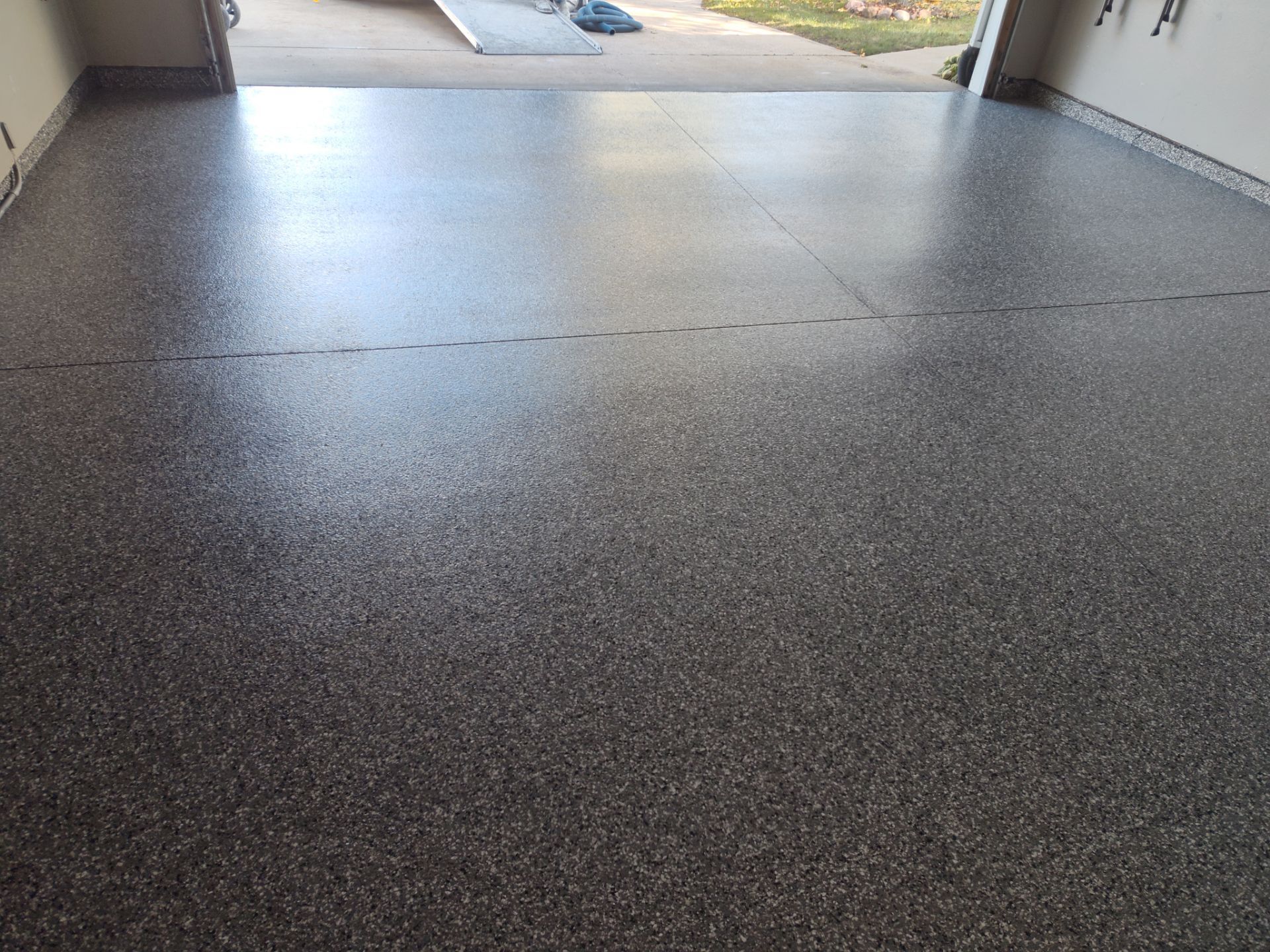 Close Up View of This Customer's New Flake Coating by Revival Concrete Coatings