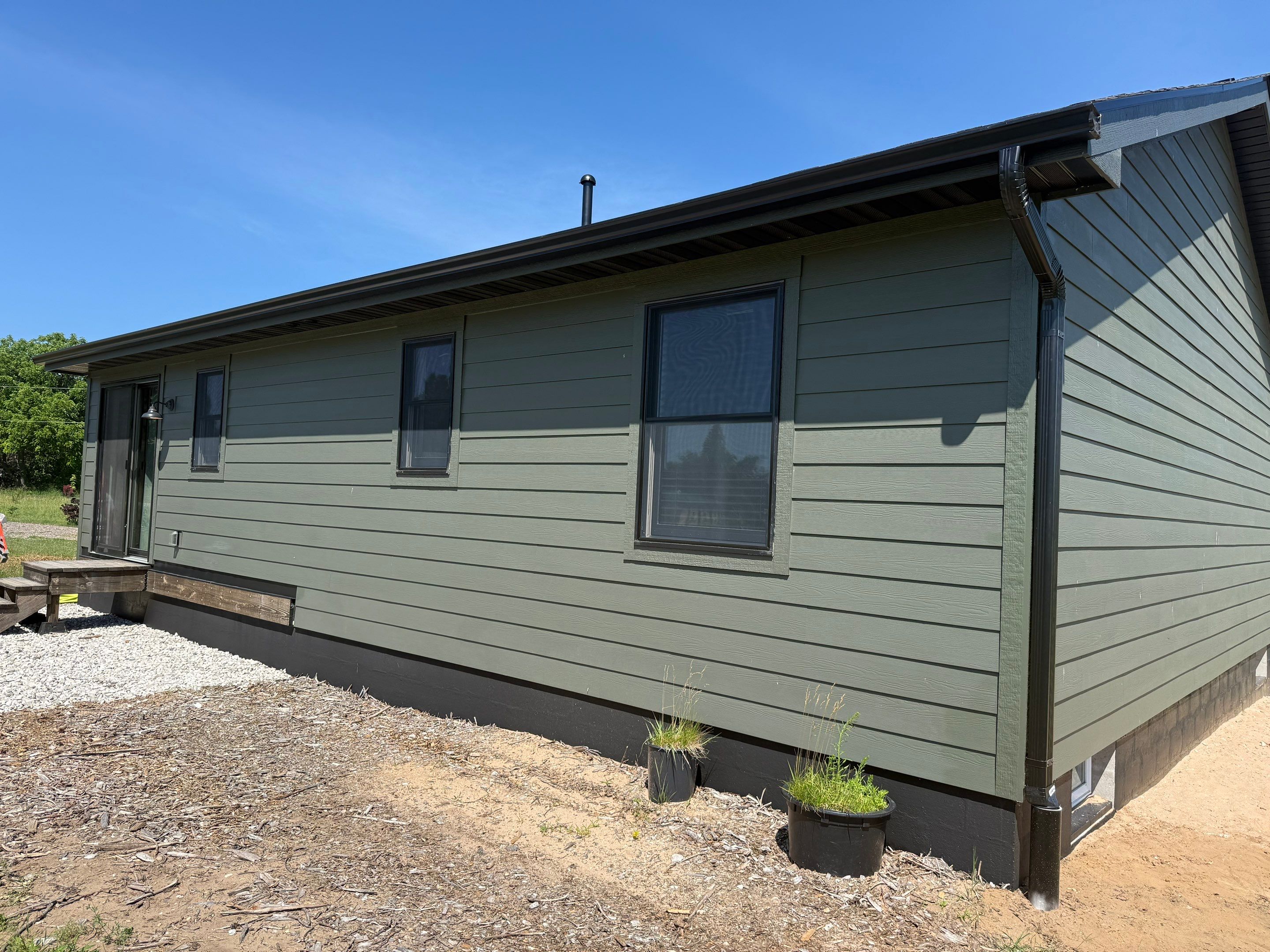 Seamless Black Gutter and Downspout Installation in Bear Lake by Rainbow Seamless Systems