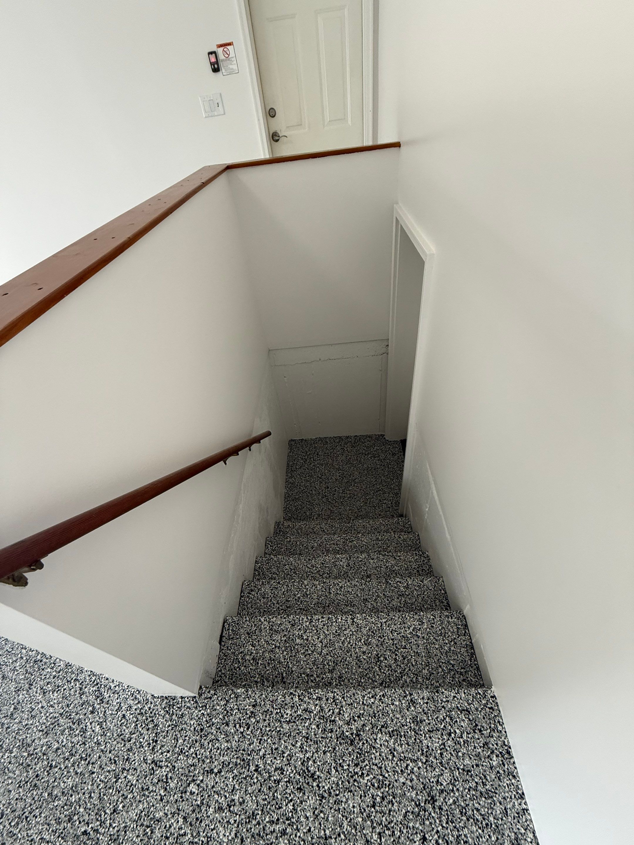 Full Garage Floor and Basement Stair Epoxy Coating in Sioux Falls by Select Painting, Coatings & Garage Cabinets