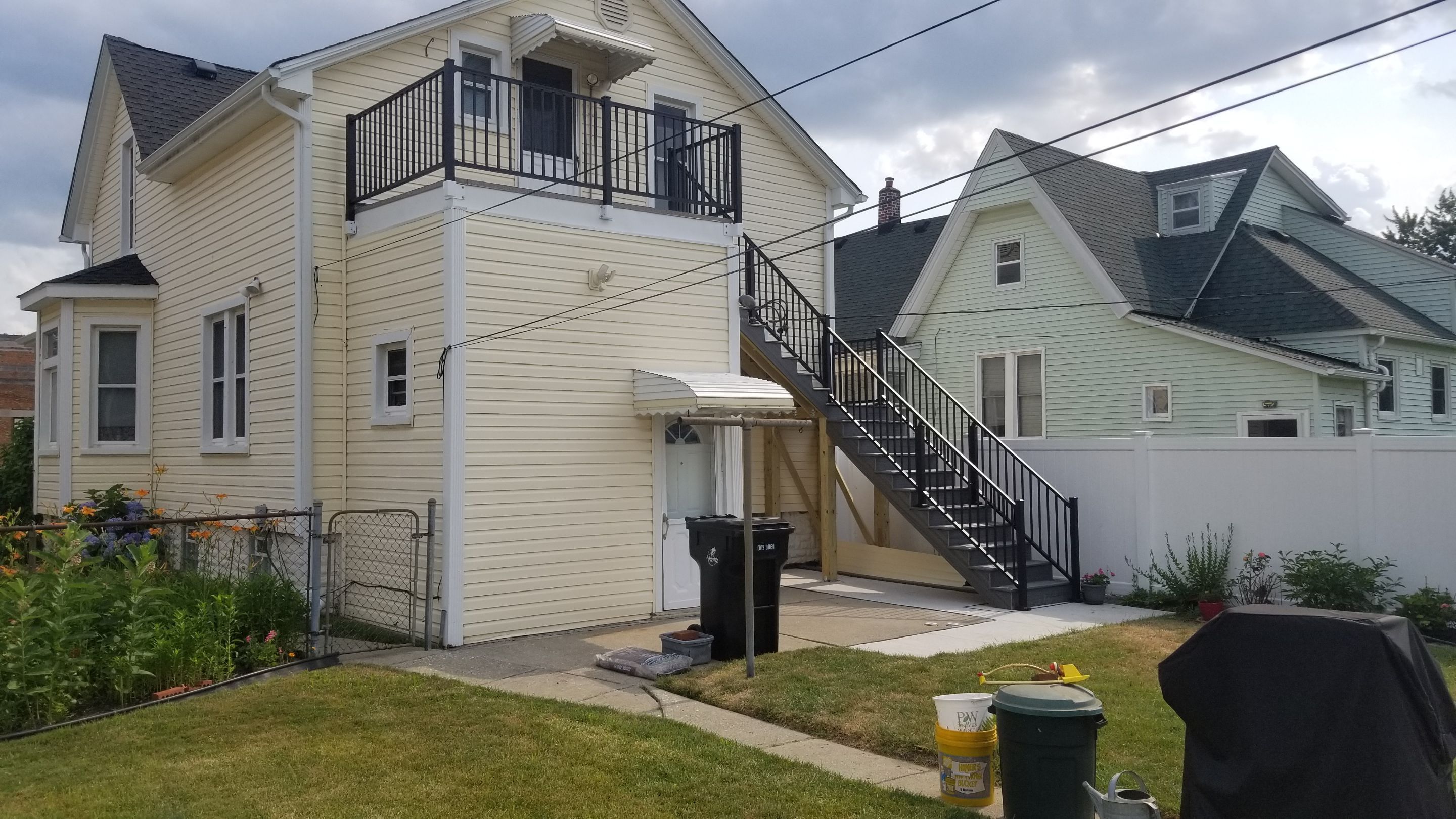 Rebuild balcony flat roofing TREX decking stairway and Railings in Wyandotte, MI by Northwest Construction 
