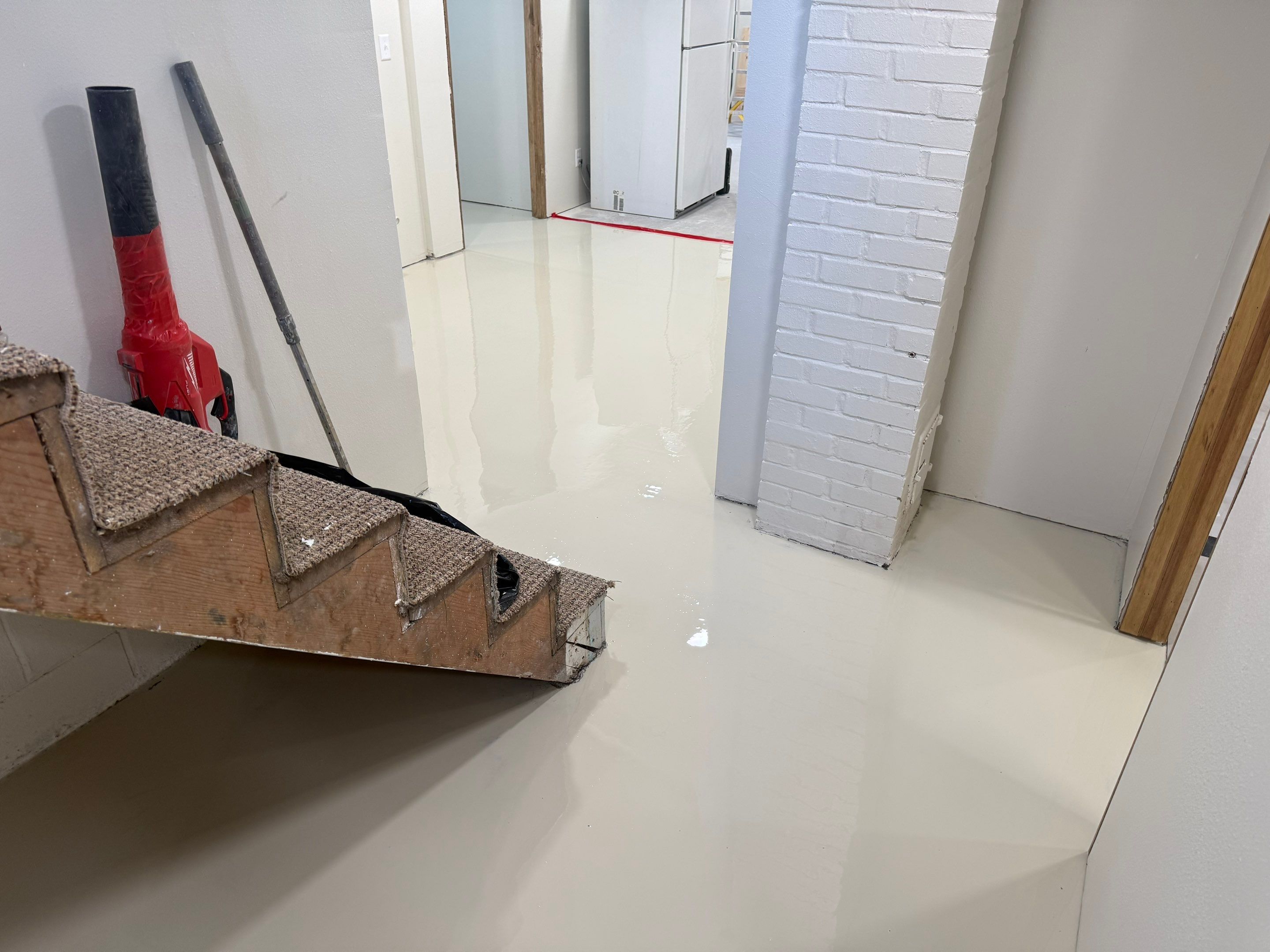 High-Gloss Epoxy Floor Coating and Basement Renovation in Rock Rapids by Select Painting, Coatings & Garage Cabinets
