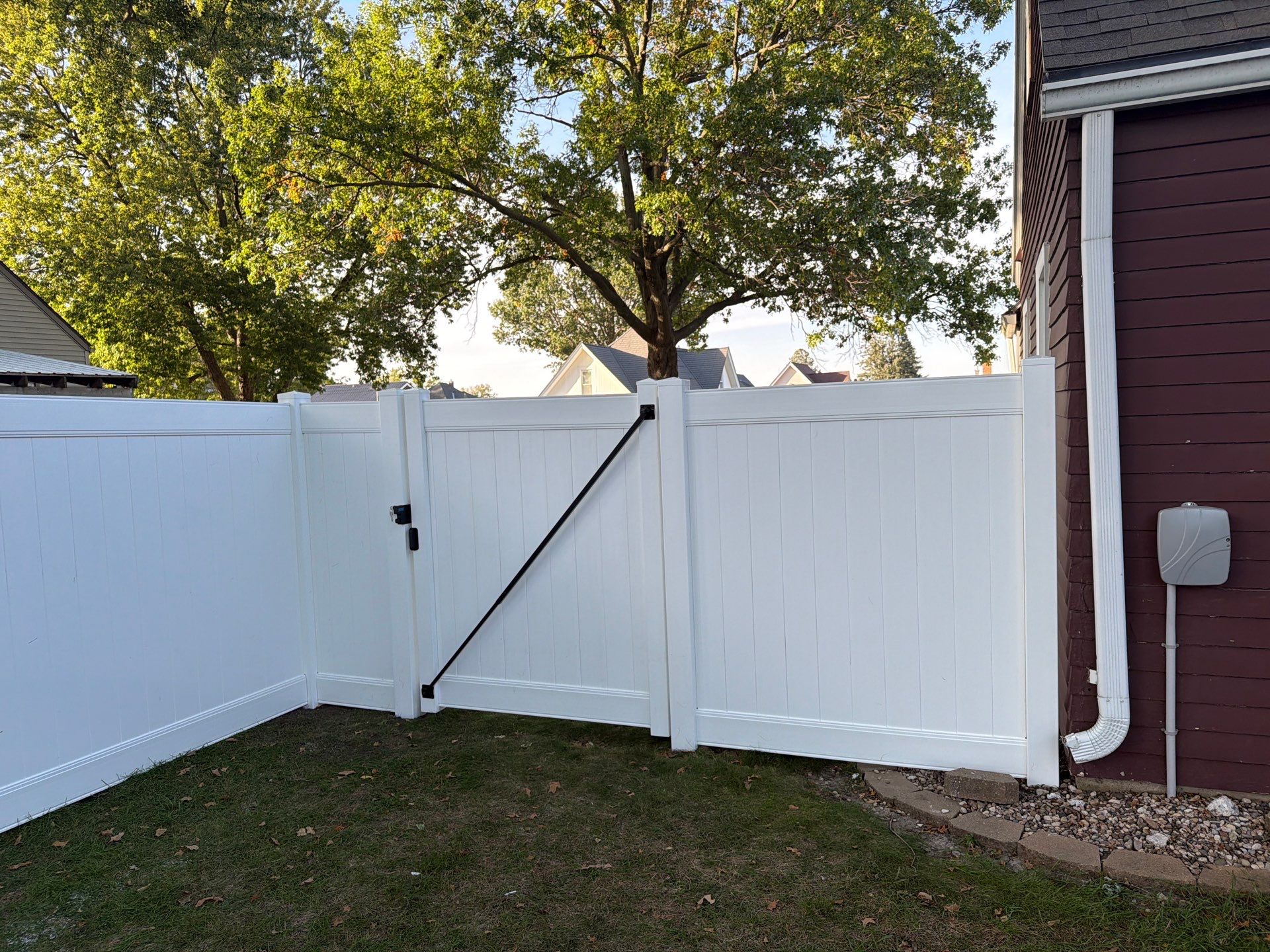 White Vinyl Privacy Fence and Gate Installation in Grundy Center by Perfect Picket Fence and Stain