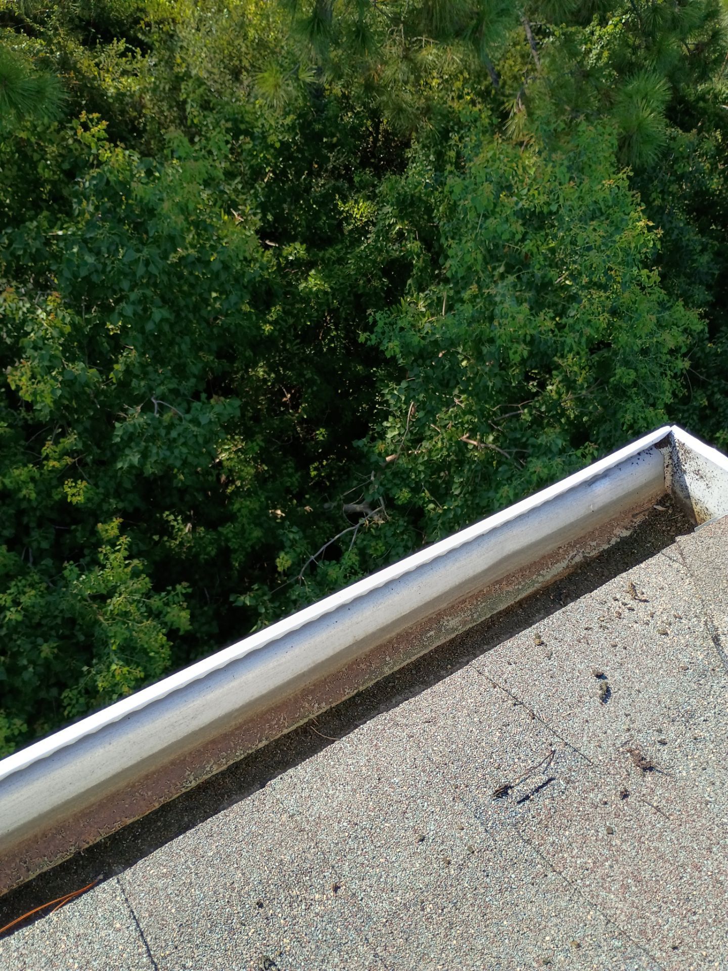 HOA gutter cleaning in Panama City Beach, FL, after  photo showing full gutters.