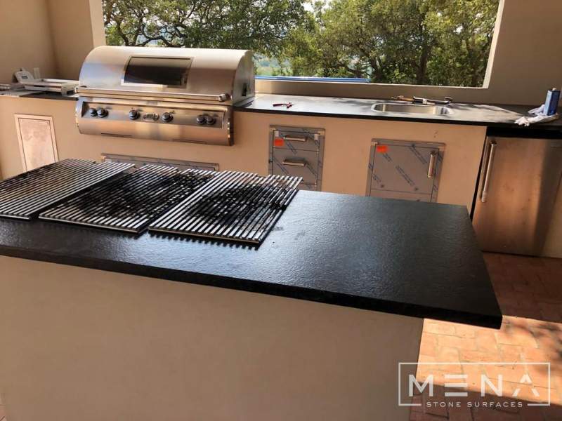 Kitchen, outdoor kitchen and pool brick floor installation by Mena stone surfaces