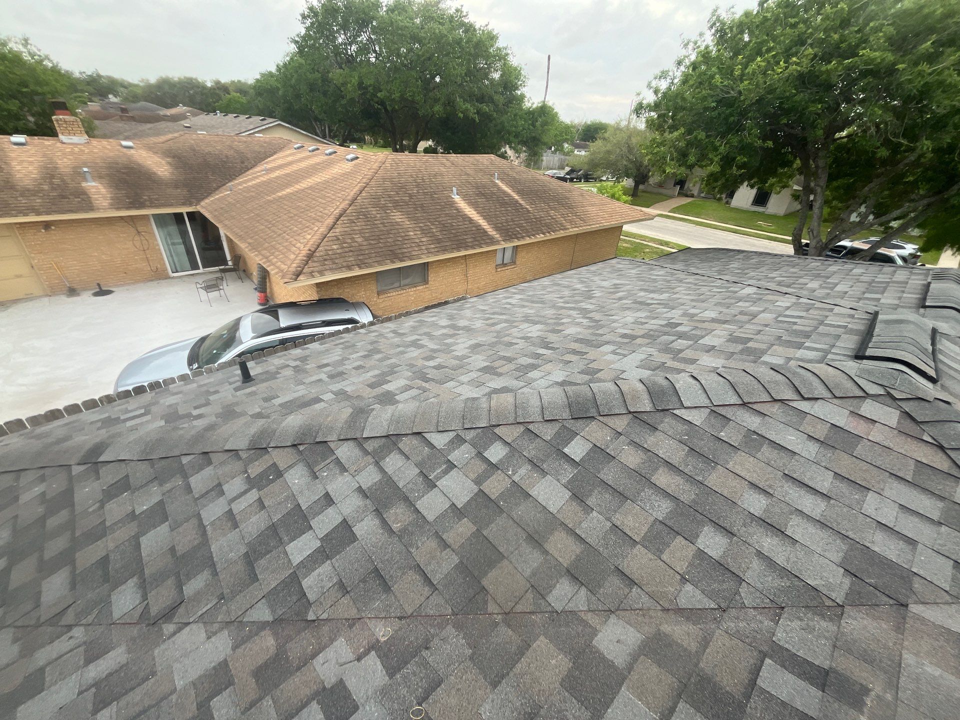 Colored Vinyl Windows to blend into brick by Bayfront Roofing and Construction