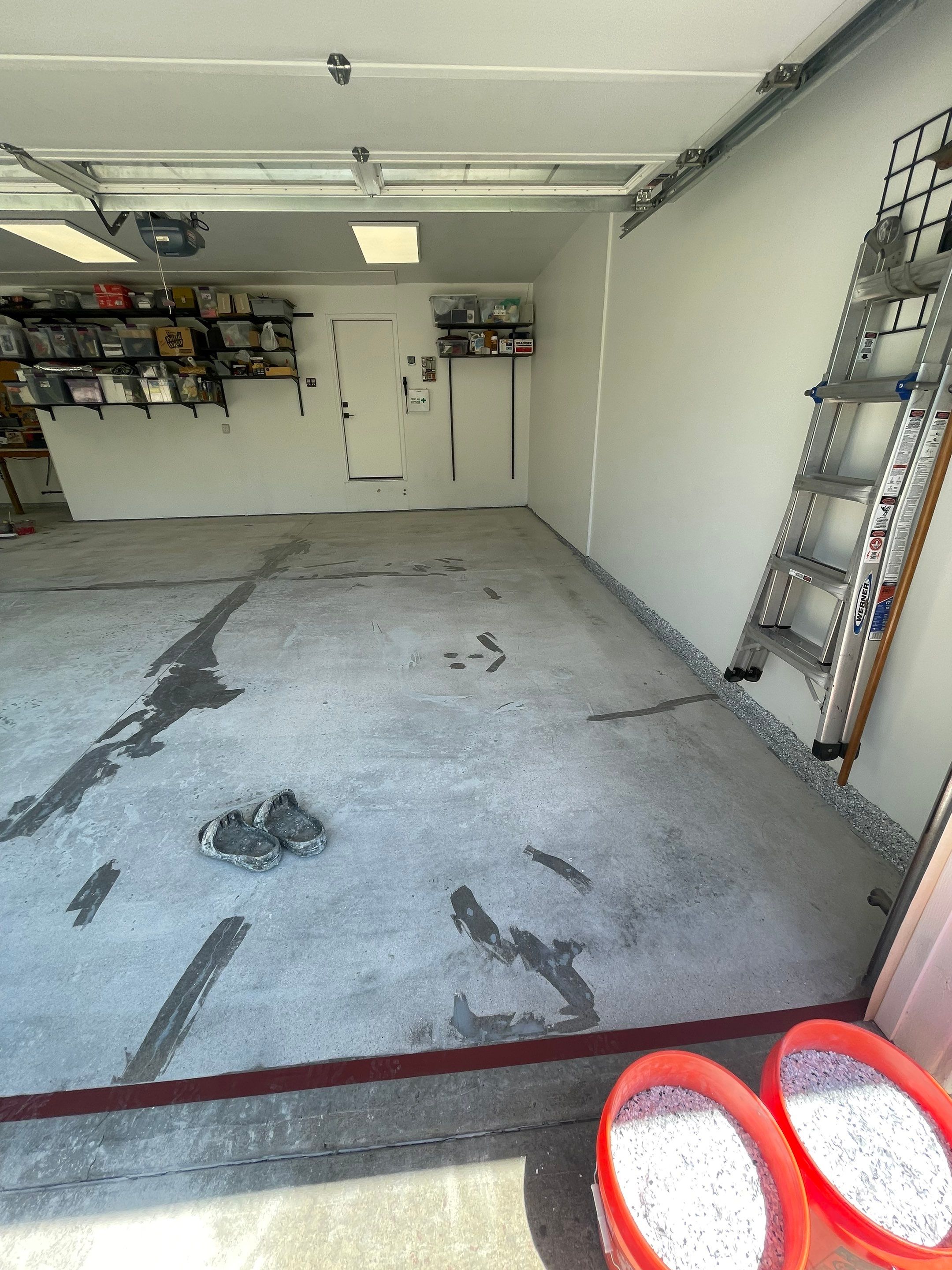 Feather Grey Garage Floor Coating Installation in Sioux Falls by Select Painting, Coatings & Garage Cabinets