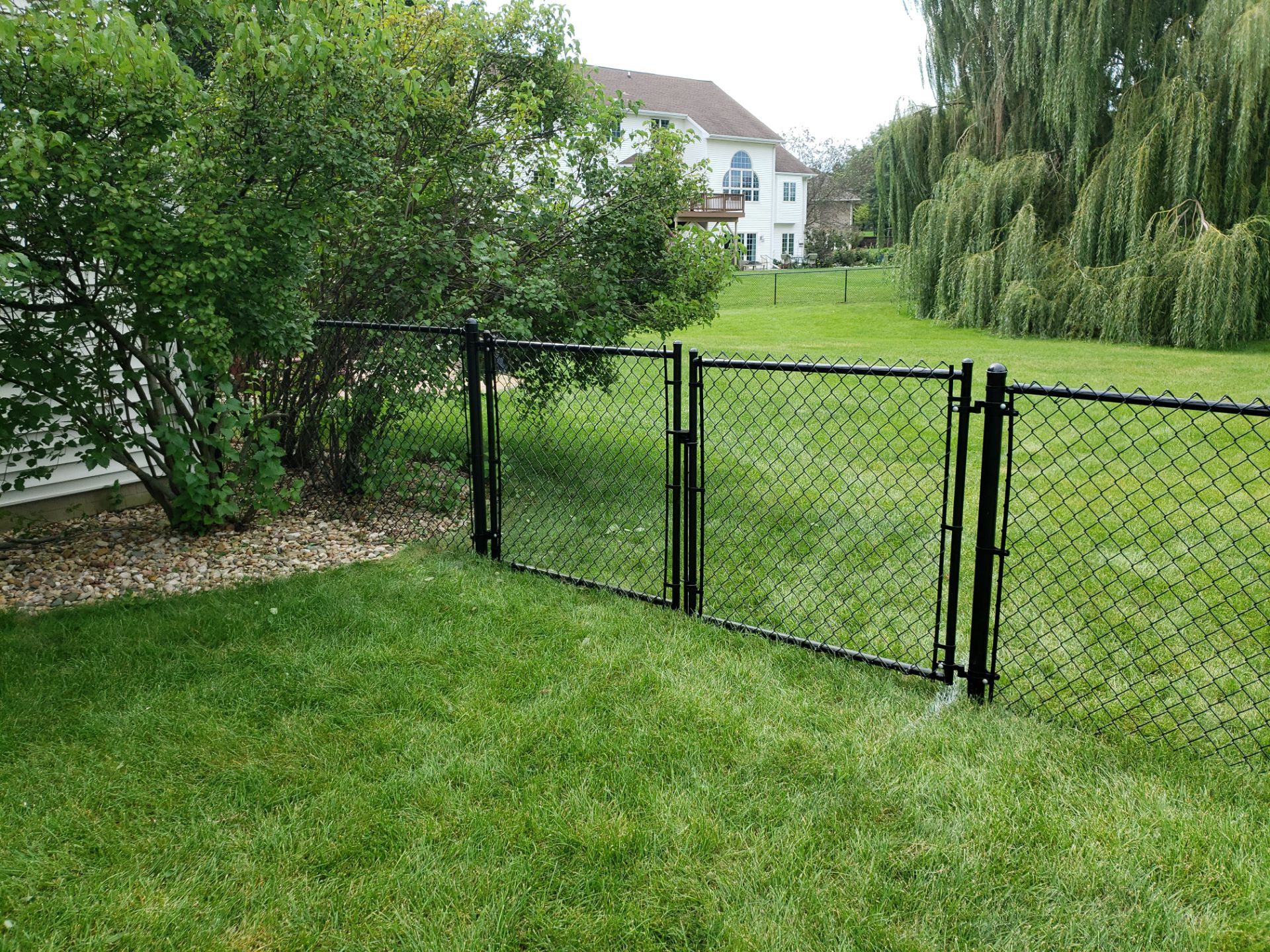 Black Vinyl-Coated Chain Link Fence Installation in Cedar Falls by Perfect Picket Fence and Stain