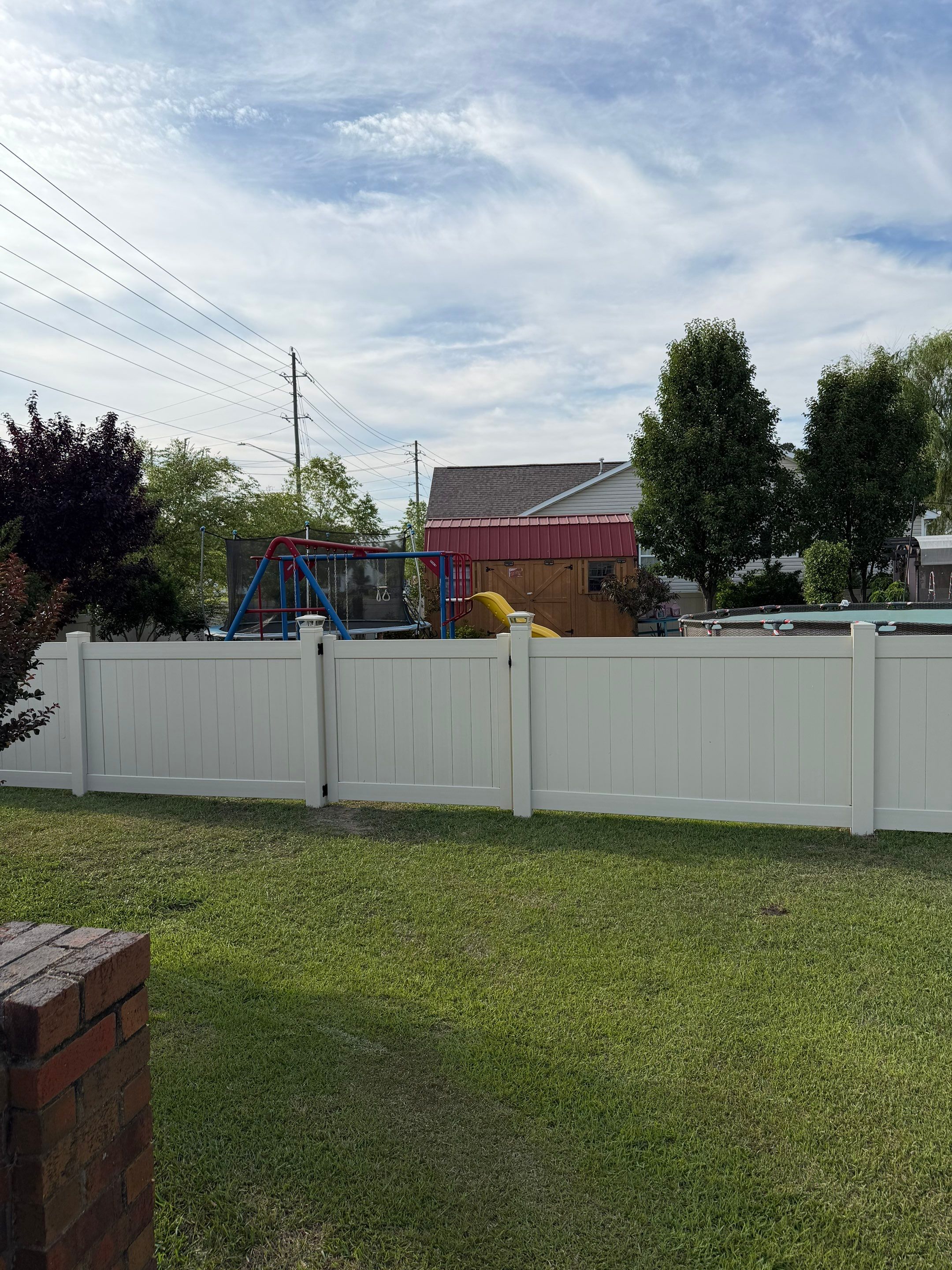 Residential Tan Vinyl Privacy Fence Installation in Winterville by Superior Fence and Rail