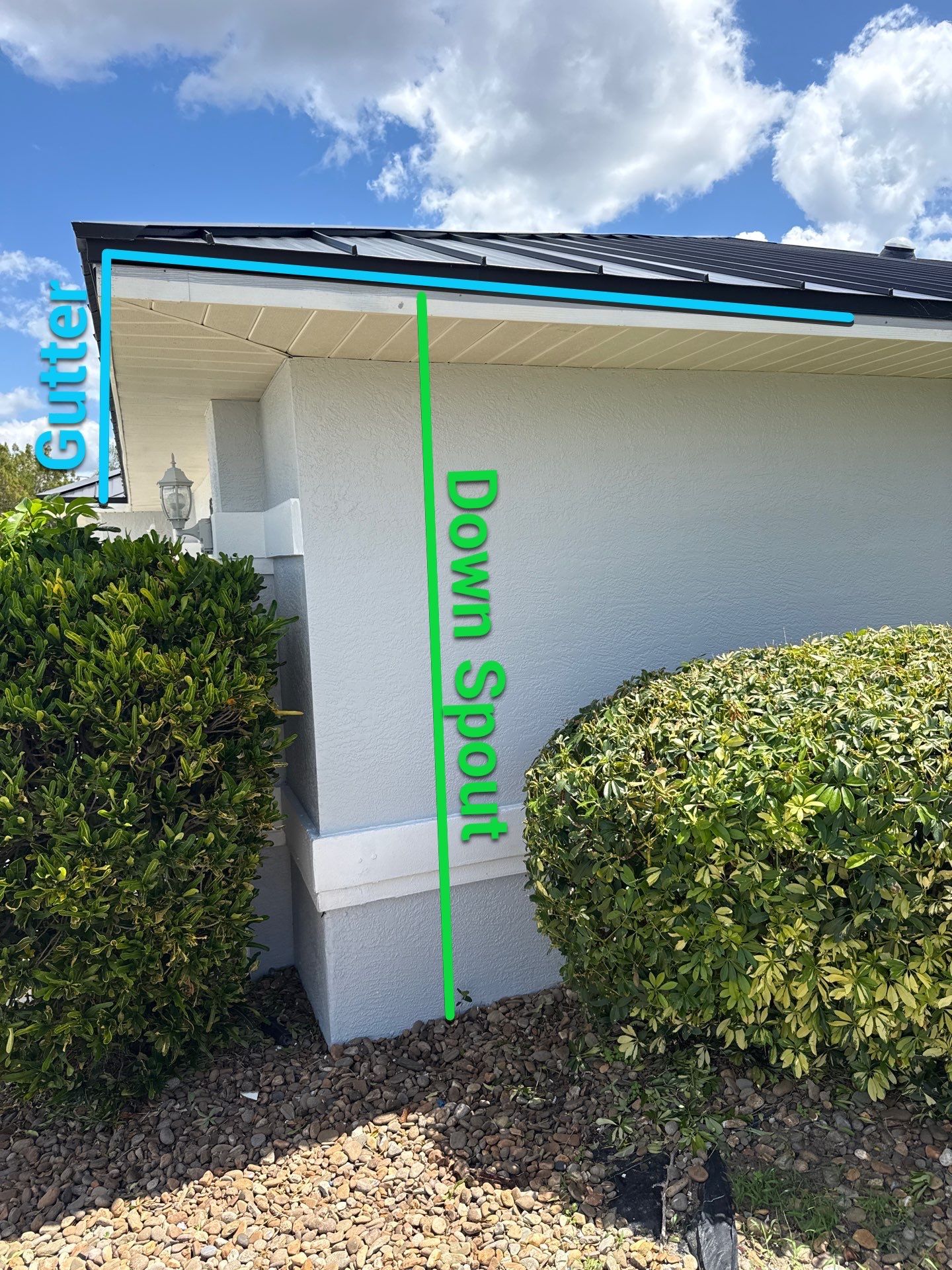 Black Seamless Gutters and White Downspouts in Cape Coral FL by Gutter Professors