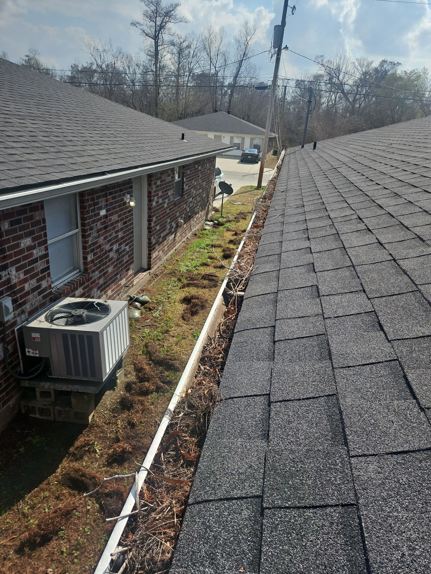 Commercial gutter cleaning New Orleans before photo with filled gutters