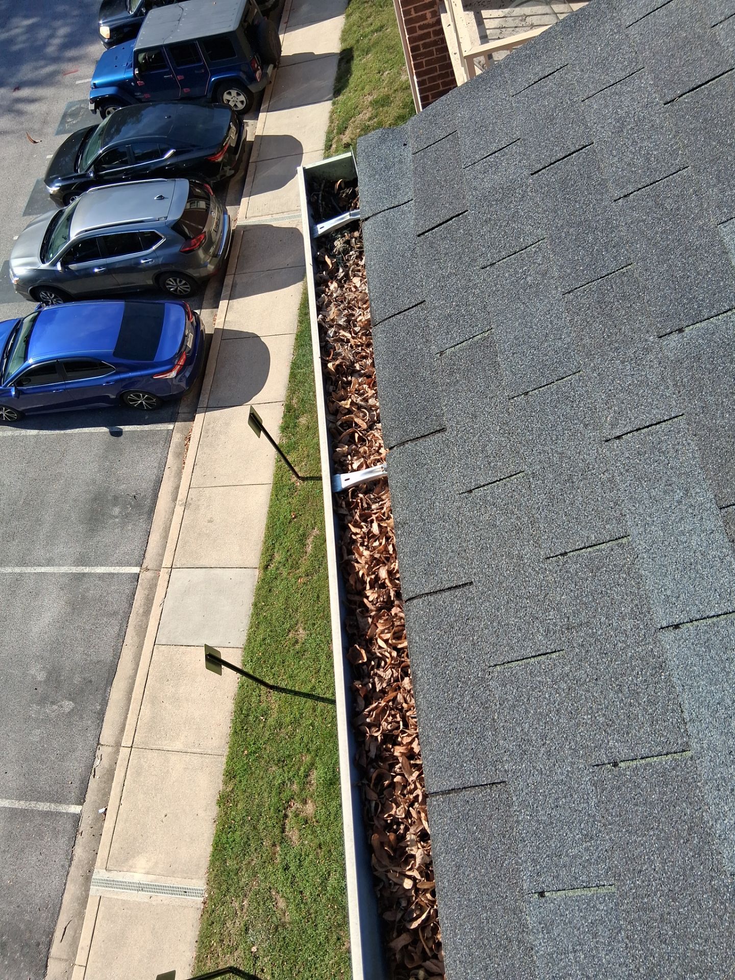 Commercial gutter cleaning Columbia & Ellicott City, MD before photo with filled gutters