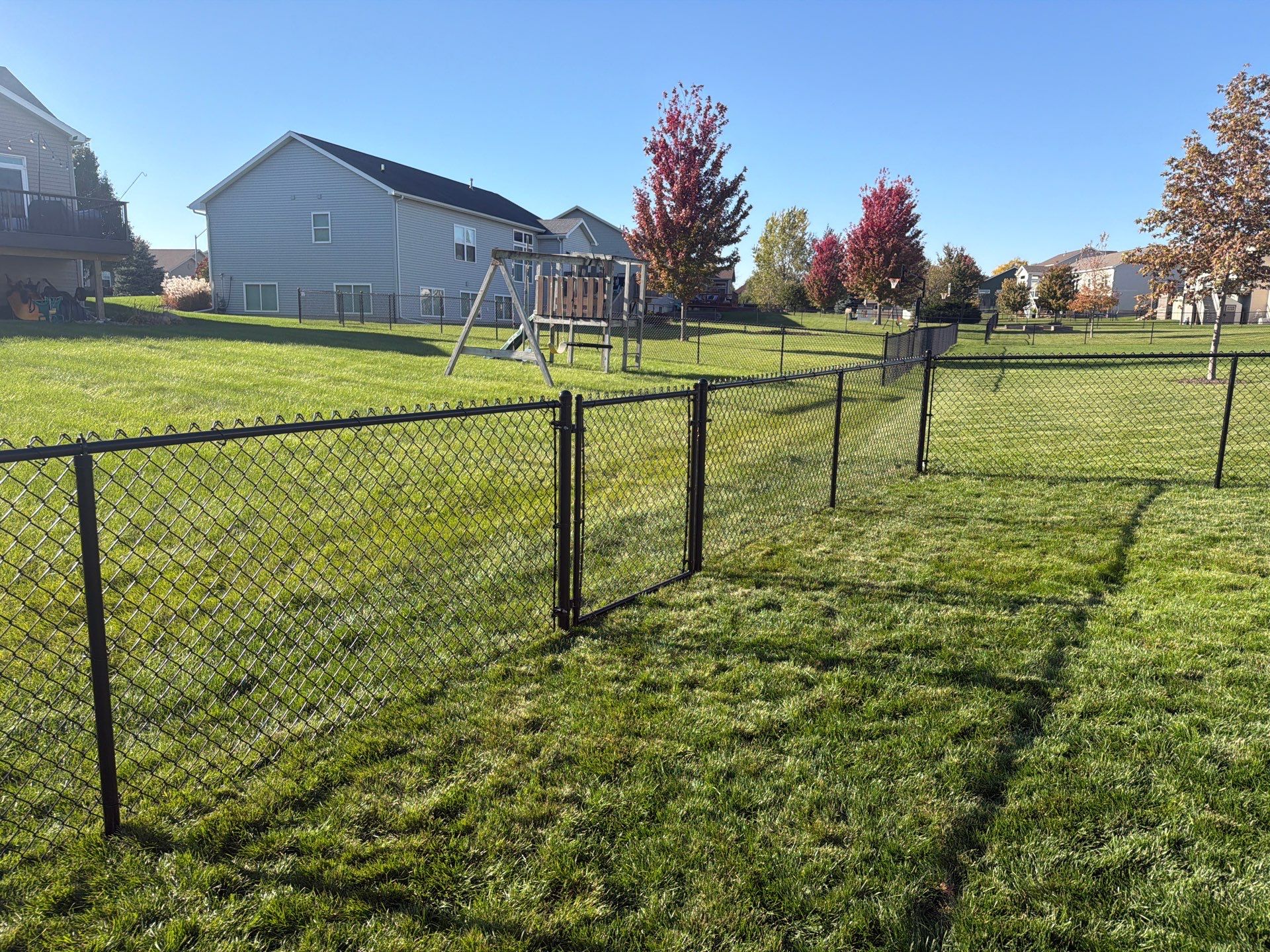 Black Vinyl-Coated Chain Link Fence Installation in Cedar Falls by Perfect Picket Fence and Stain