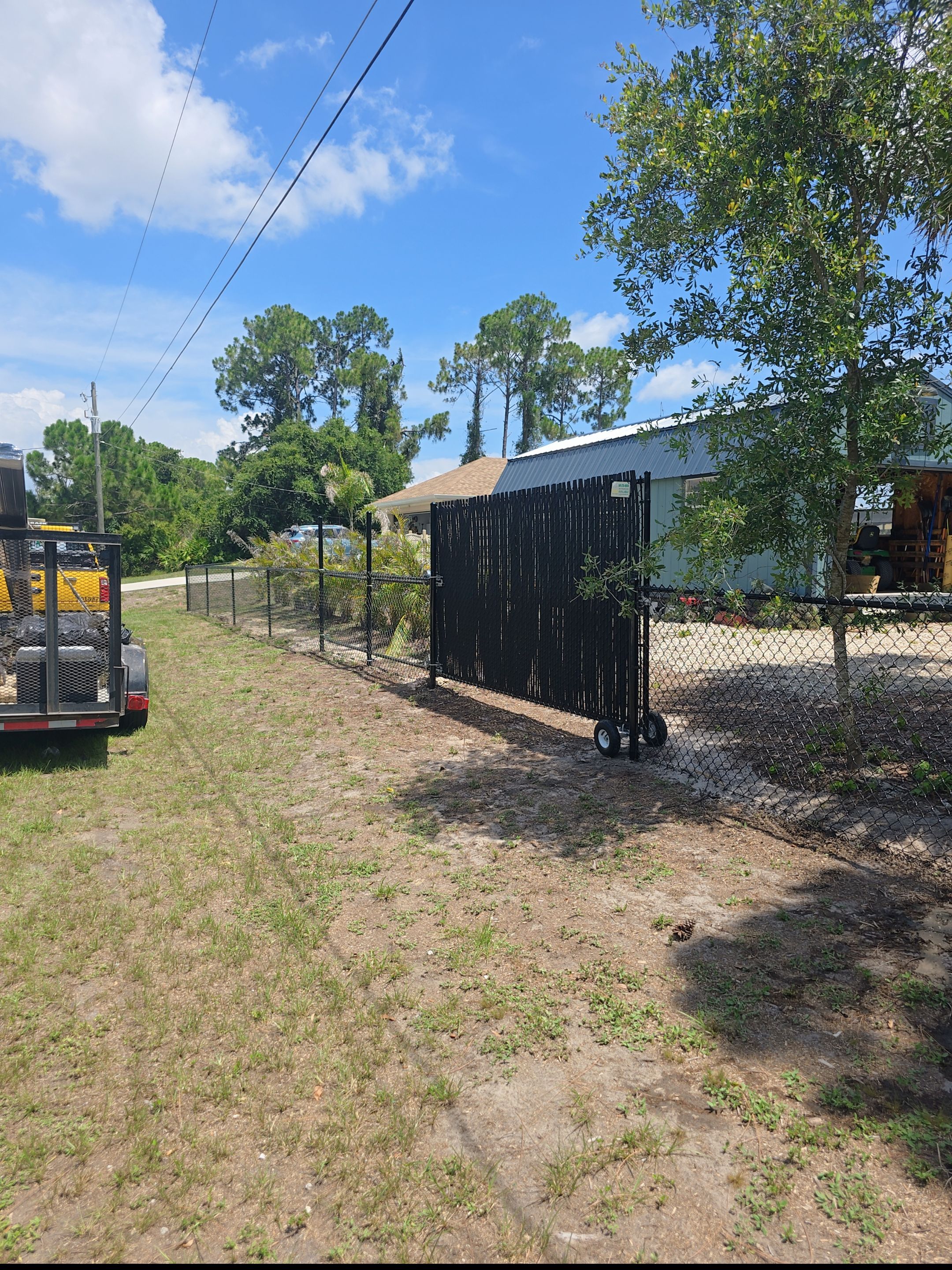 Black Vinyl-Coated Chain Link Fence and Rolling Gate Installation in North Port by True Fence LLC