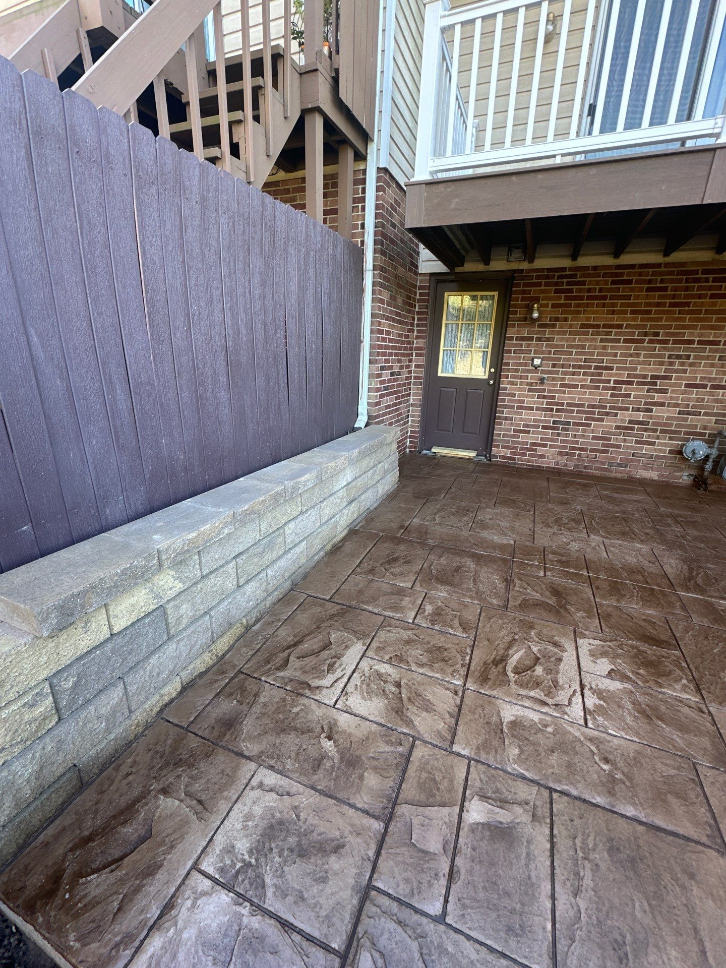Stamped concrete and redeck  by Cousins Roofing Siding & Decks