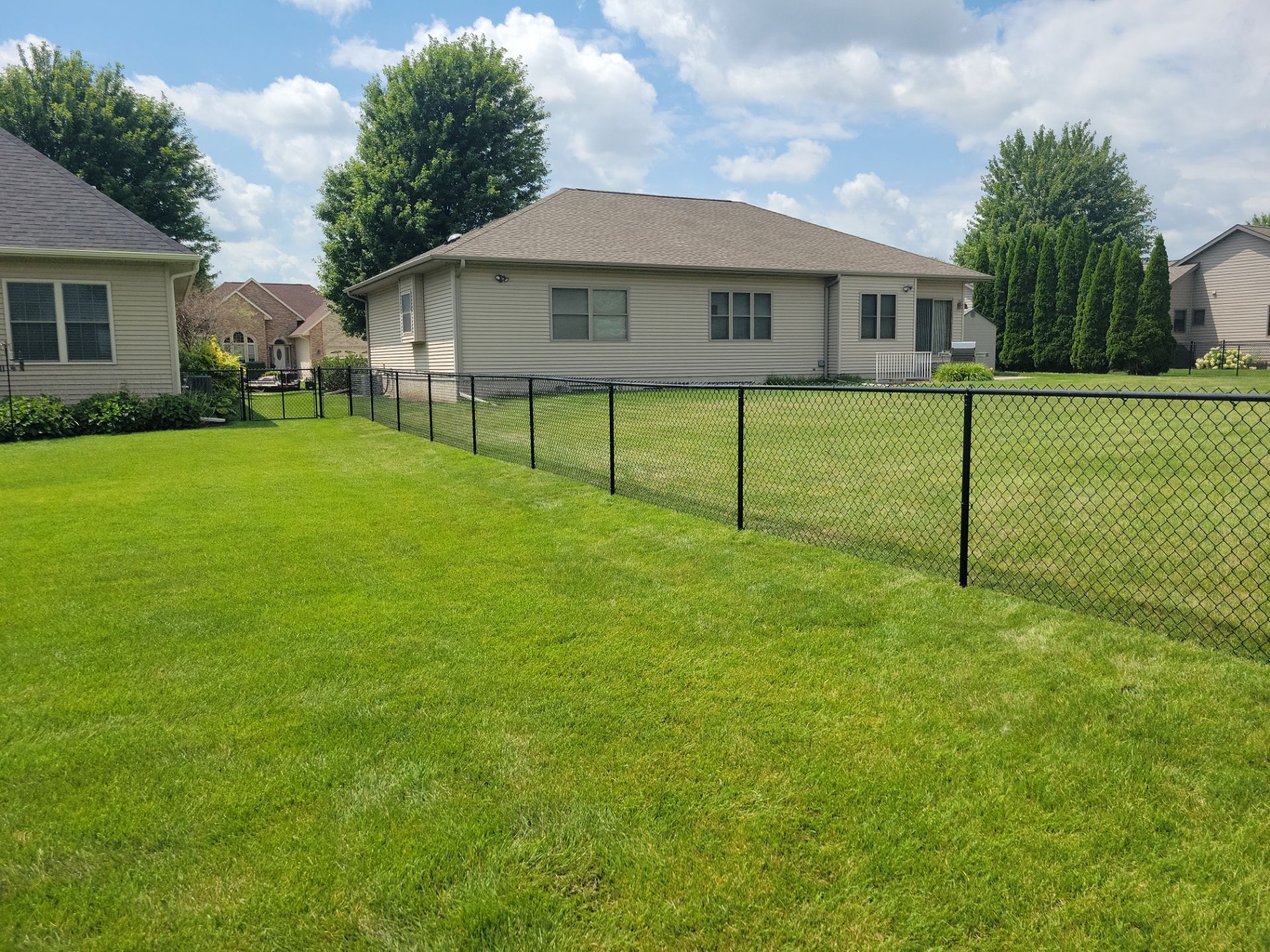 Black Vinyl Coated Chain Link Fence Installation in Cedar Falls by Perfect Picket Fence and Stain