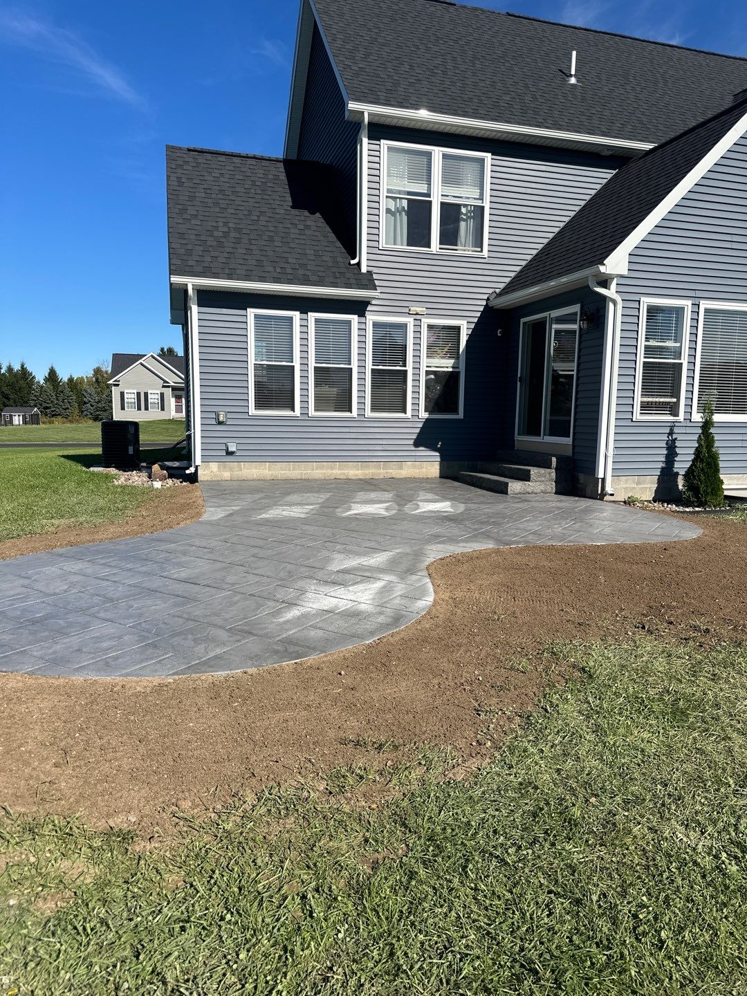 Majestic Ashlar stamped concrete patio with rock face steps  by NG Masonry & Construction LLC