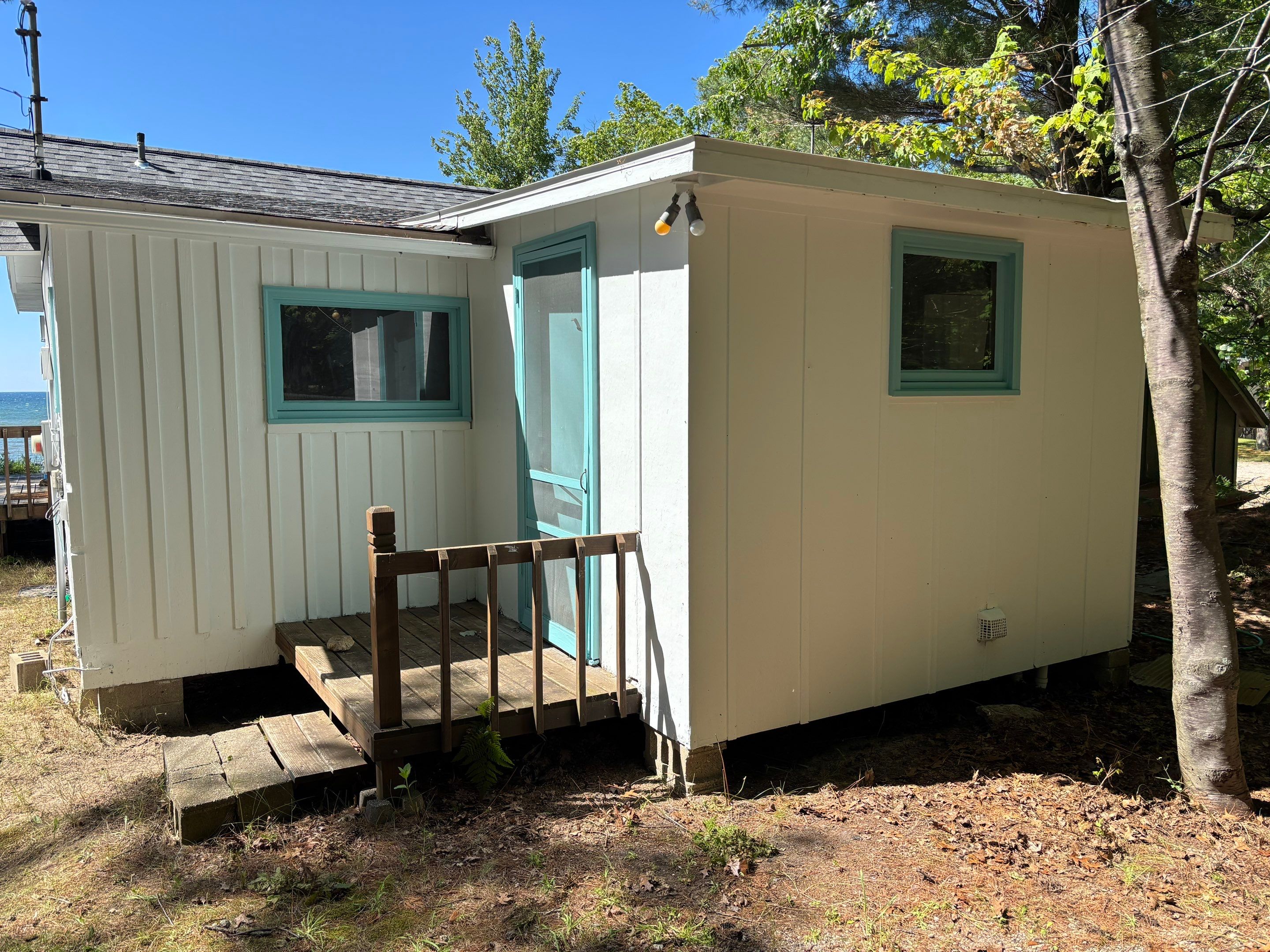Lakeside Cottage Exterior Painting and Teal Trim Restoration in Mears by Gordon Painting