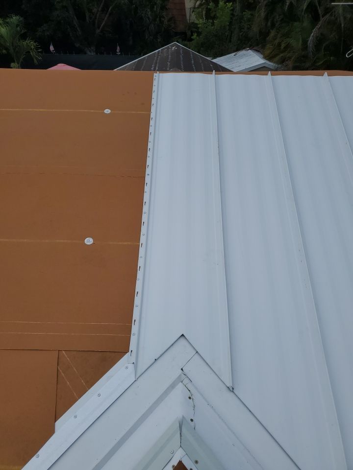 Residential Roofing Installation using 1.5" Nail Strip 24ga Solar White Kynar Coated Standing Seam Metal Panels by Morton Roofing, Inc.