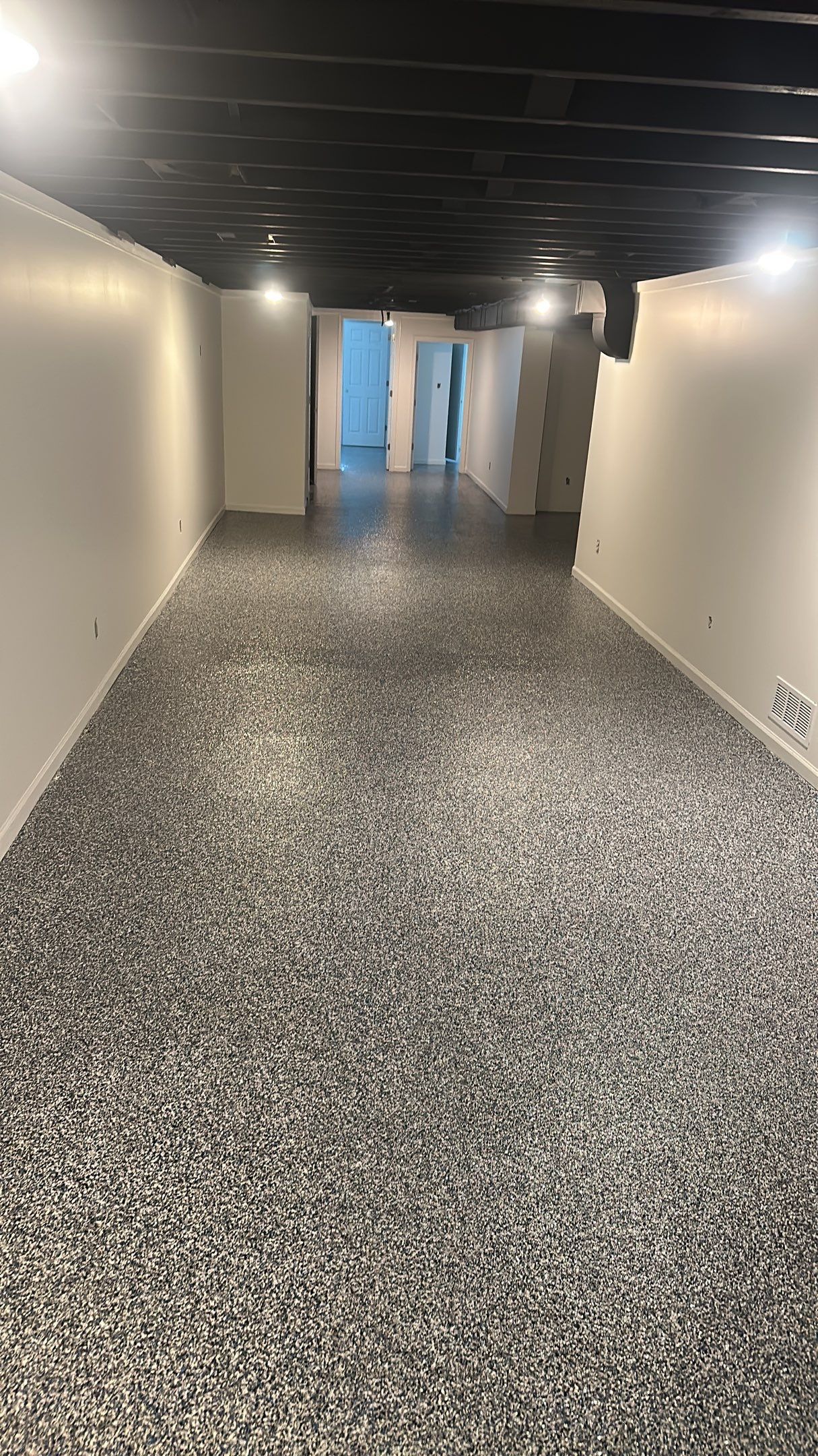A beautiful Banner Garage Coating in a basement  by Banner Garage