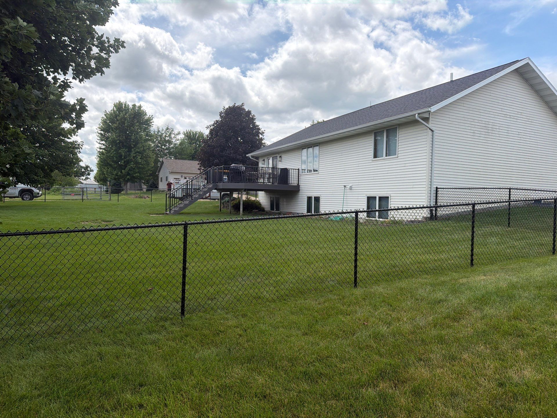 Black Vinyl-Coated Chain Link Fence Installation in Fairbank by Perfect Picket Fence and Stain