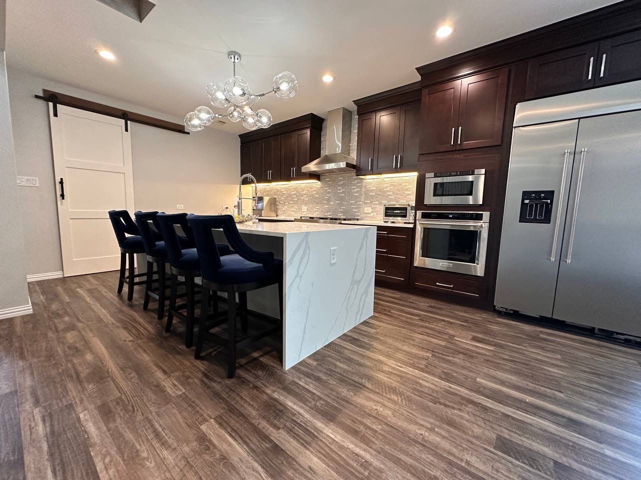 Kitchen Remodel using Calacata Quartz by Construction Nation Group
