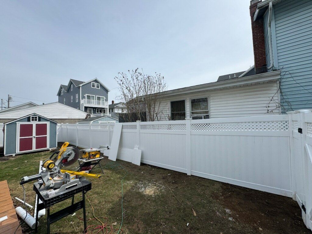 Fence install, White vinyl privacy fence with lattice accent. by DiGiorgi Roofing and Siding Inc