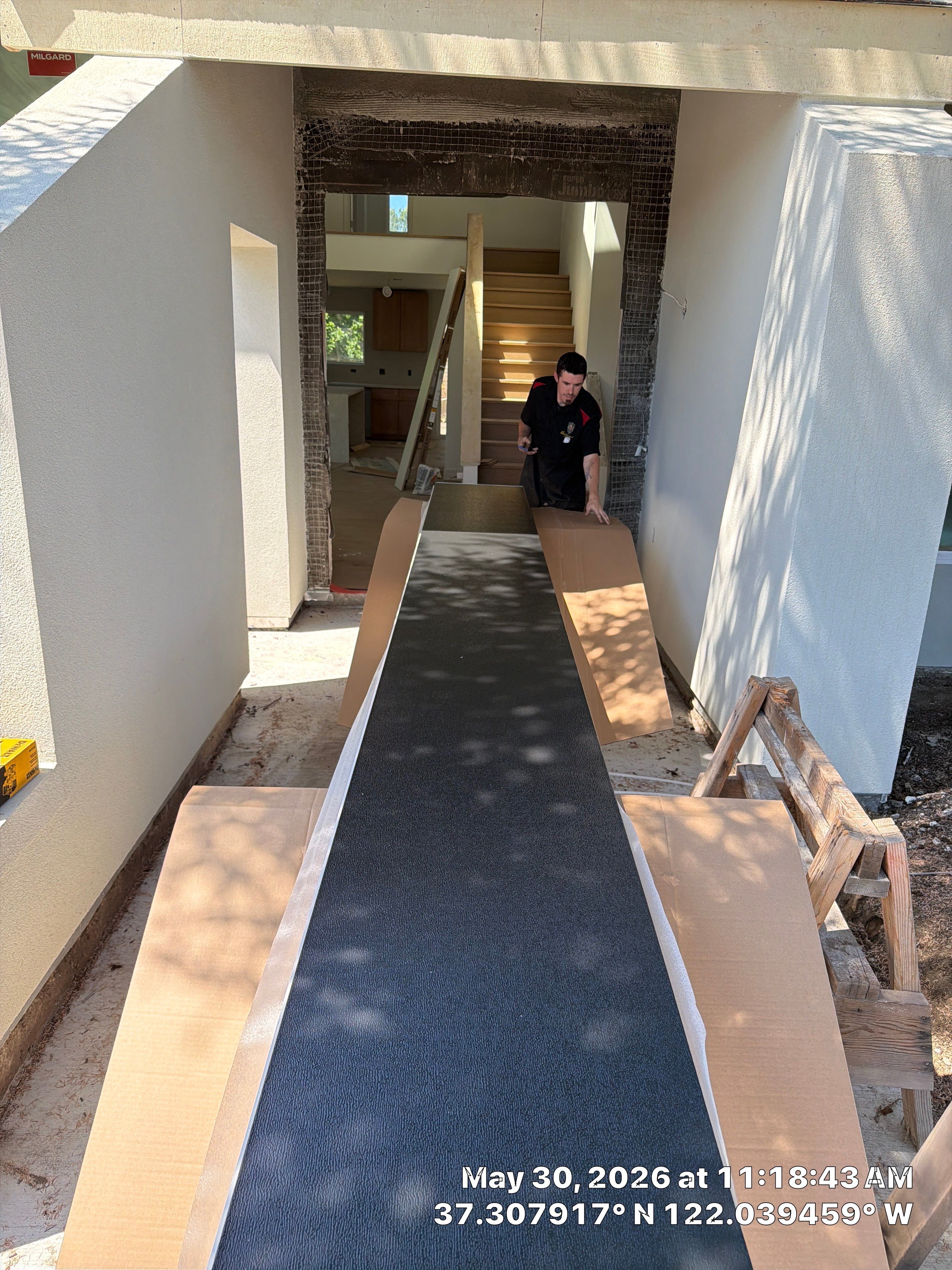 Modern Black Garage Door Installation With Vertical Windows In Cupertino by Valiant Garage Door LLC