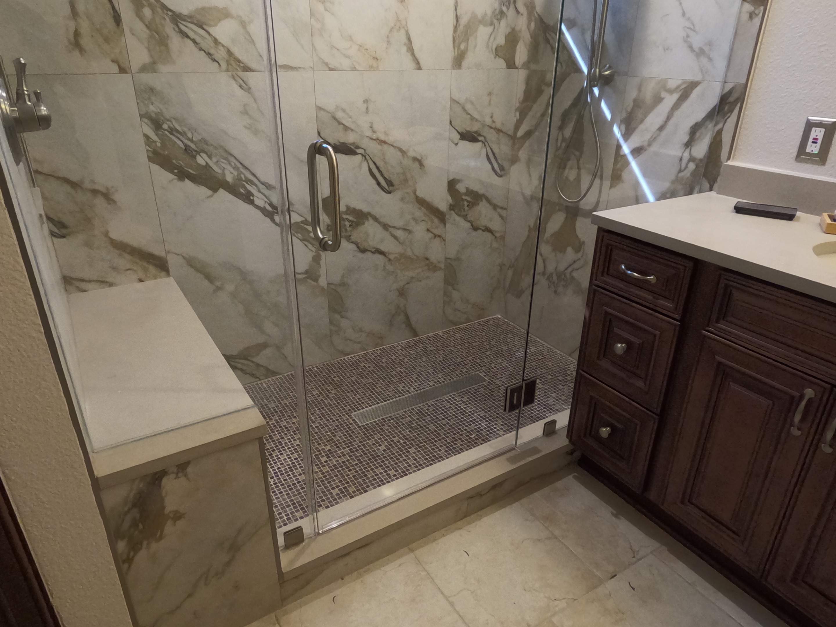 Master Bathroom Renovation Featuring Marble-Look Tile and Quartz Countertops by Mena stone surfaces