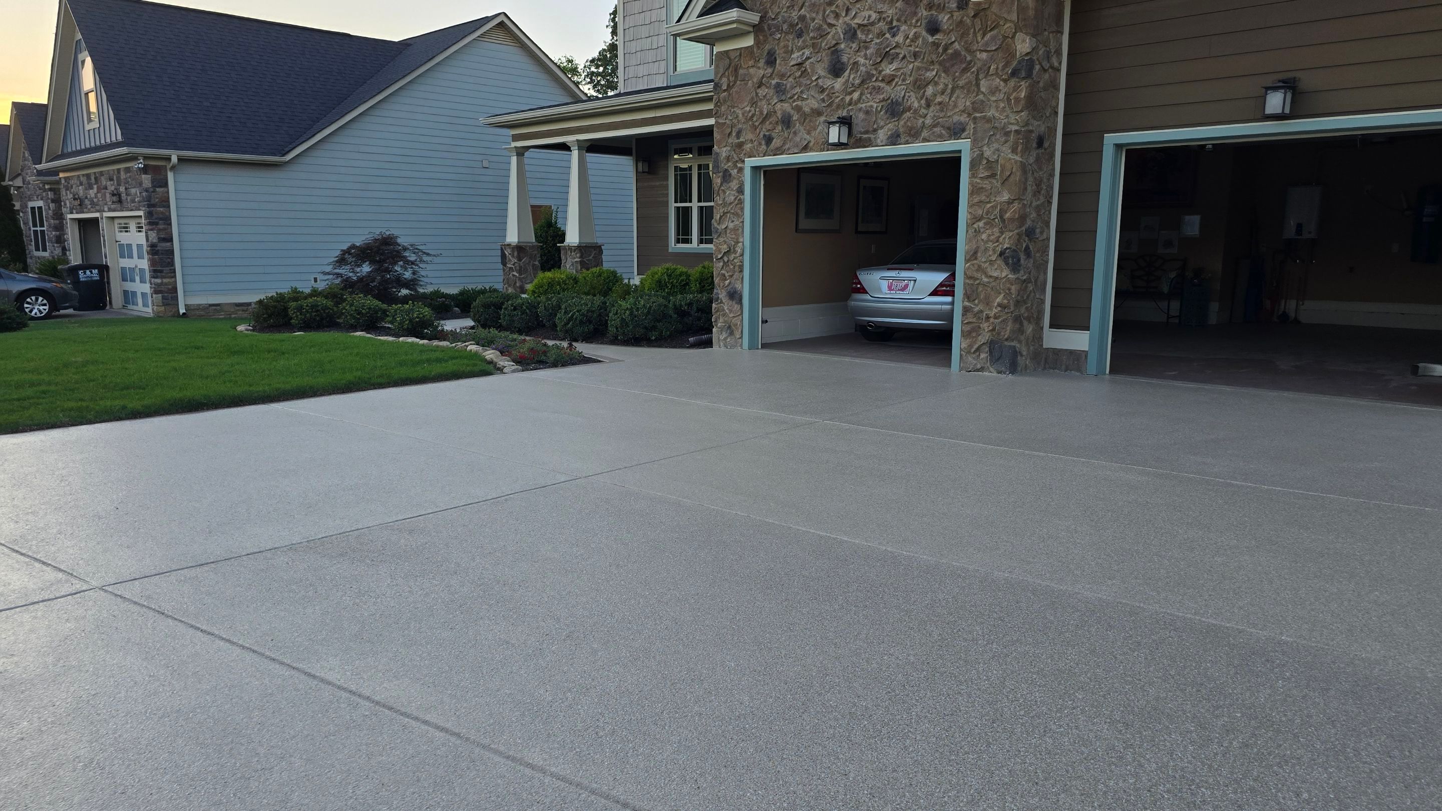 Driveway and sidewalk using Feldspar with the border done in Spilite by Elite Floor Solutions