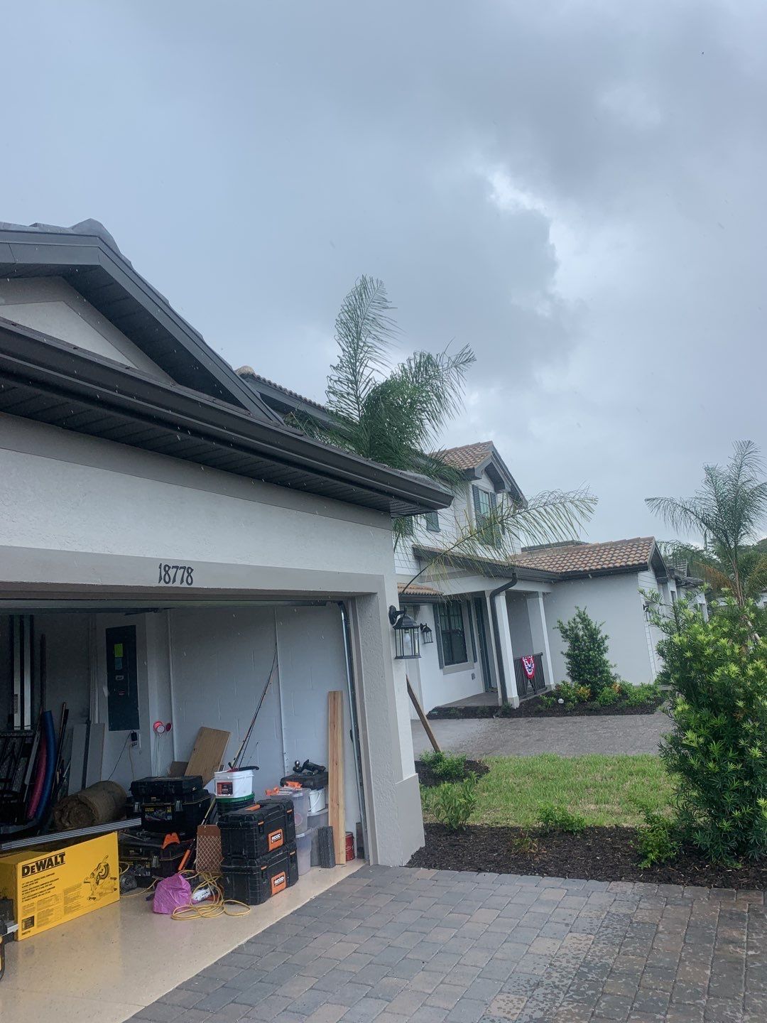 Seamless brown gutter and downspouts installation in Estero, FL  by Gutter Professors