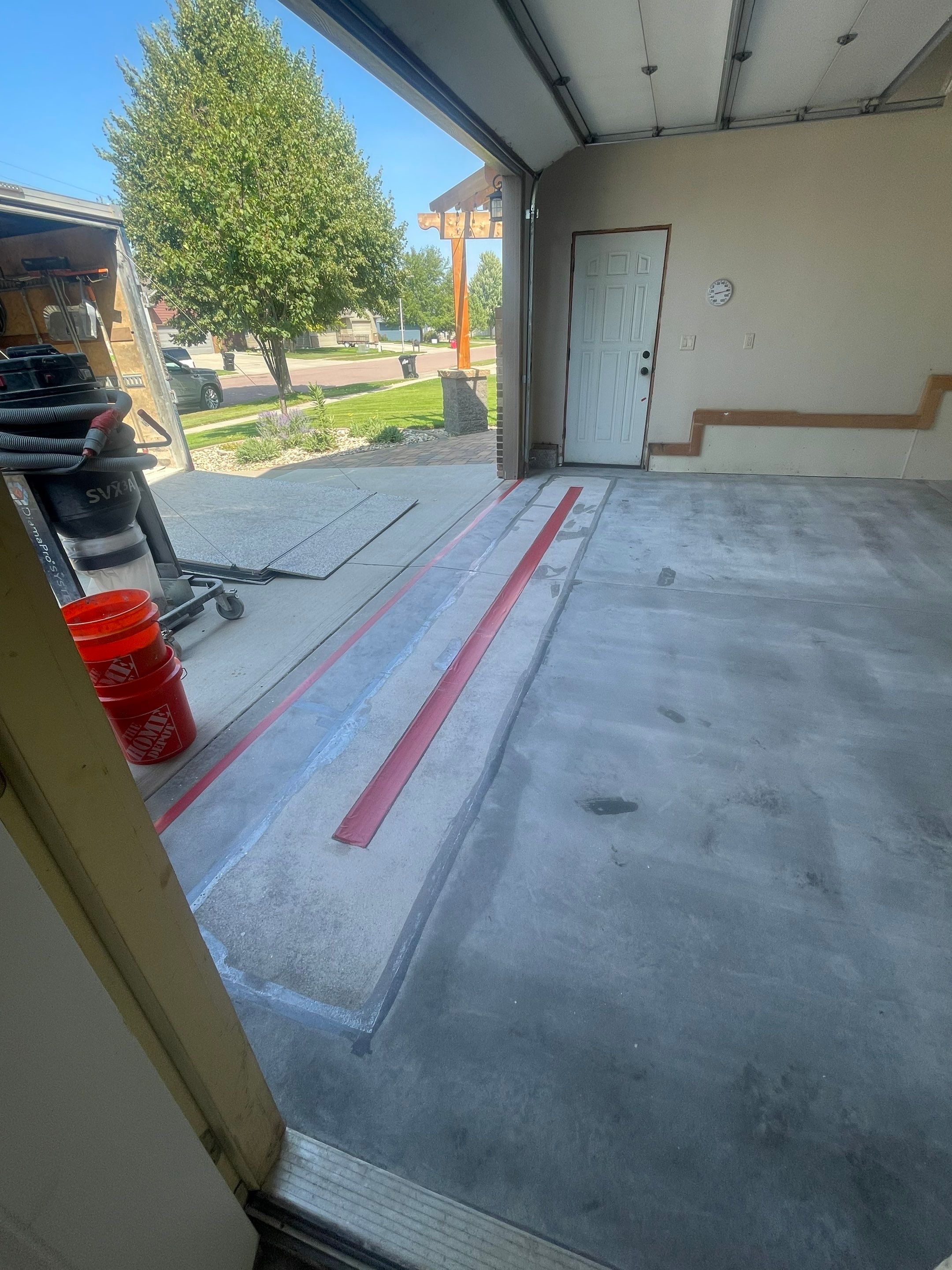 Multi-Stall Garage Floor Coating Installation in Sioux Falls by Select Painting, Coatings & Garage Cabinets