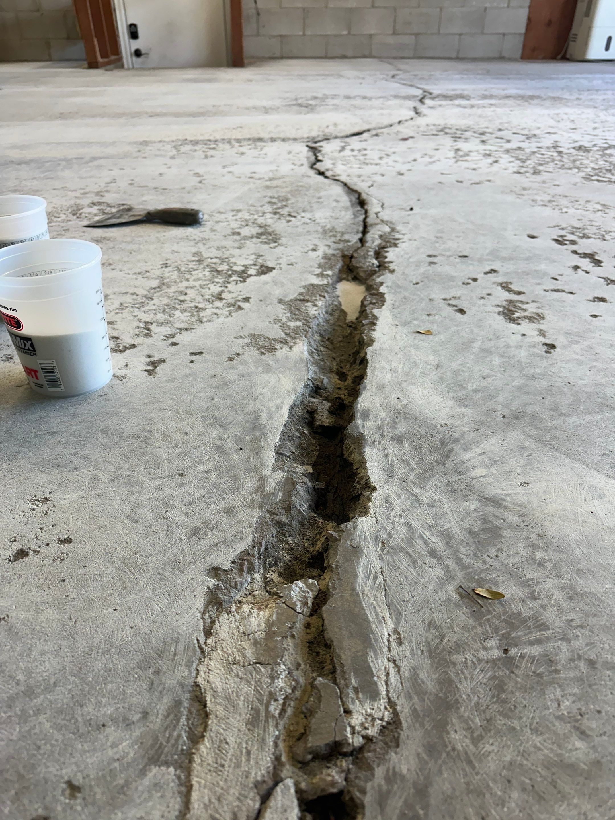 Multi-Colored Speckled Concrete Floor Coating Installation in Sioux Falls by Select Painting, Coatings & Garage Cabinets