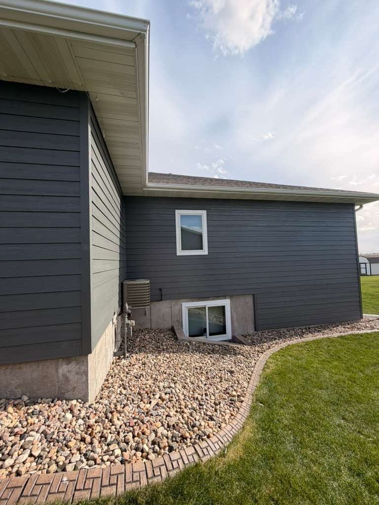 Madison Exterior Remodel with Dark Gray Siding and Stone Accents by Select Painting, Coatings & Garage Cabinets